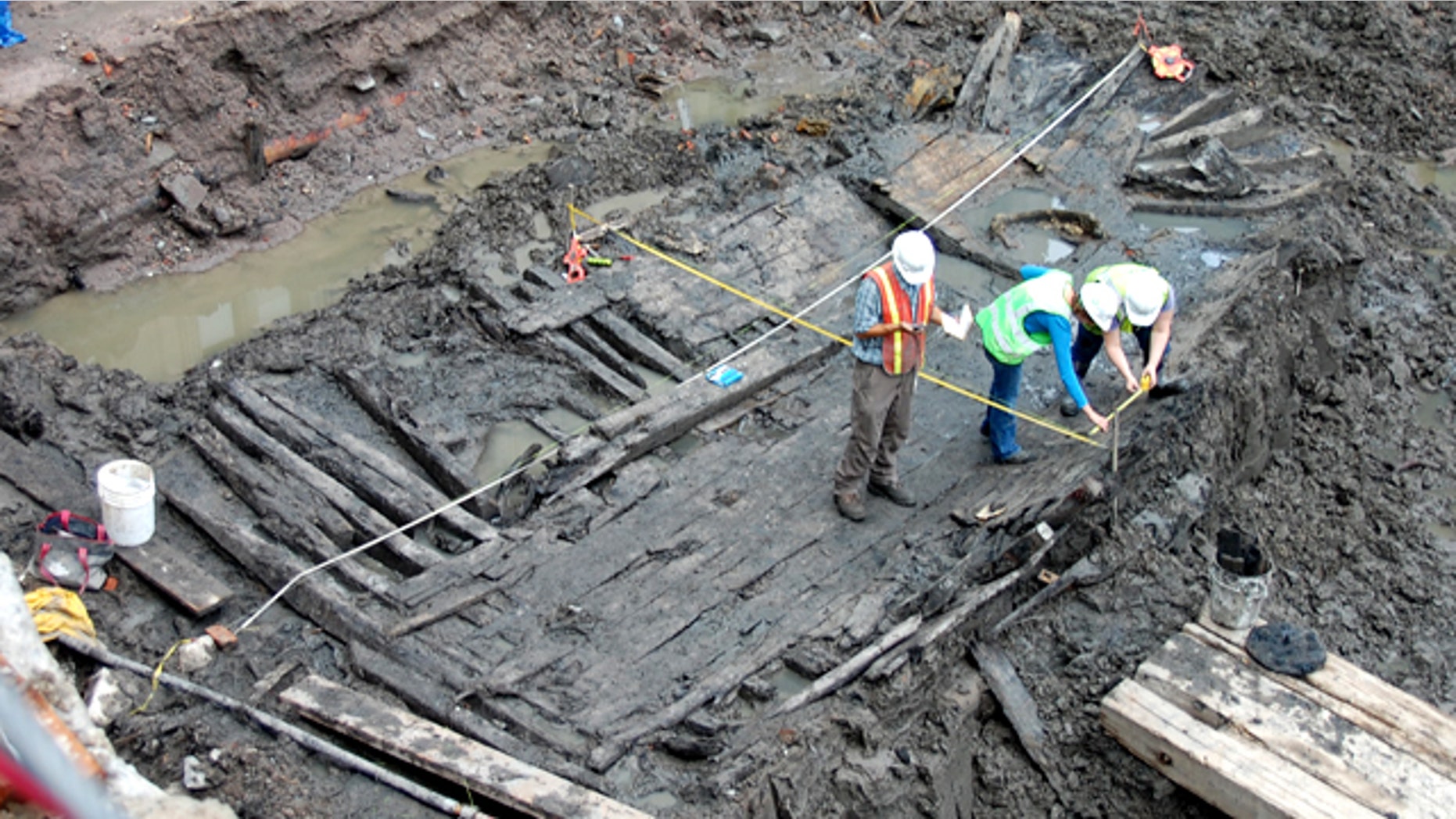 Workers at the World Trade Center in downtown Manhattan analyze a 32-foot-long ship hull found early Tuesday.
