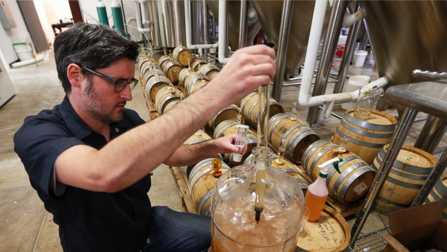 Co-Owner of Ardent Craft Ales, Kevin O'Leary, takes a sample of Persimmon beer at the facility in Richmond, VA.