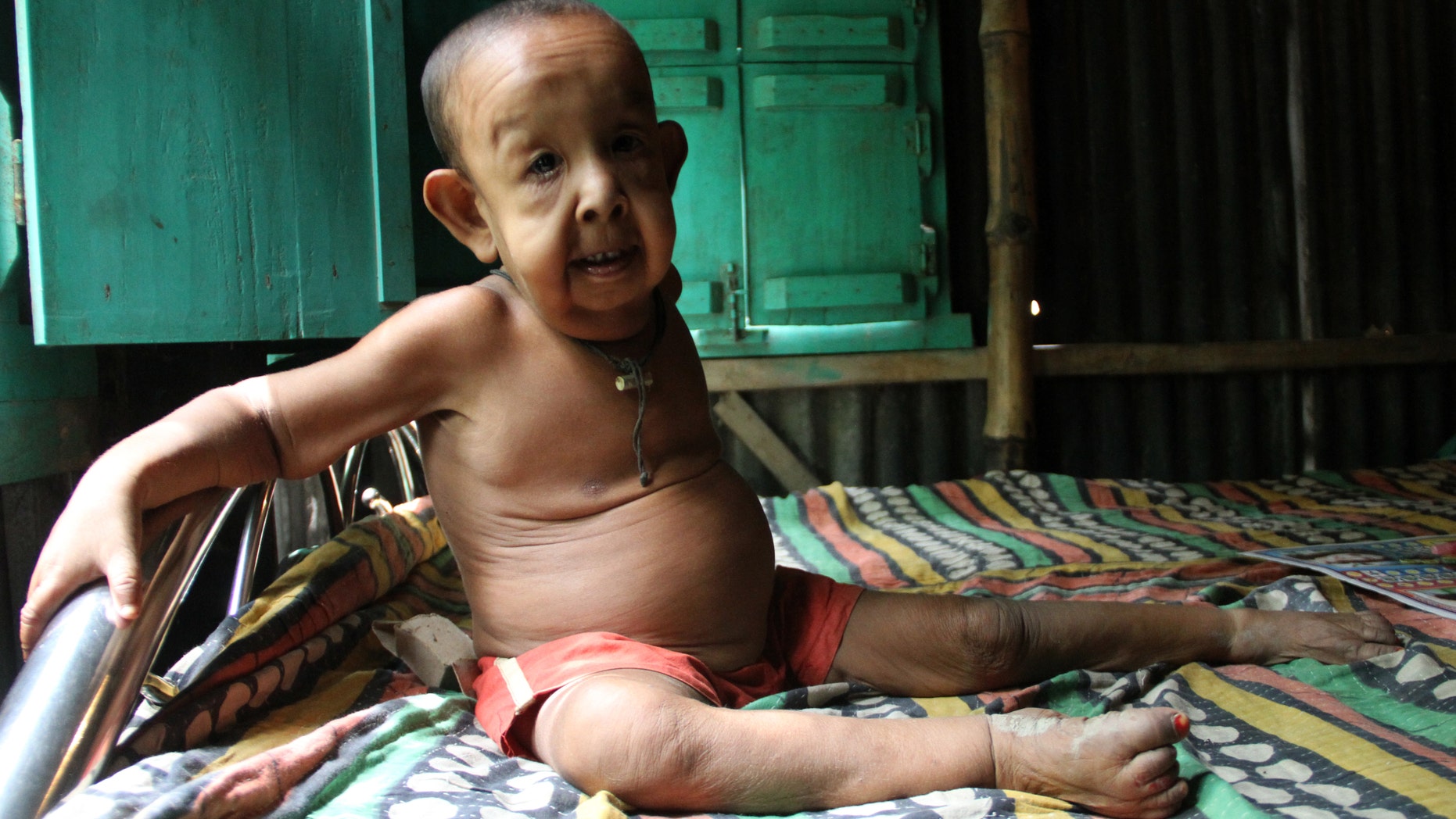 Bayazid plays alone at his home on July 20, 2016 in Magura, Bangladesh.