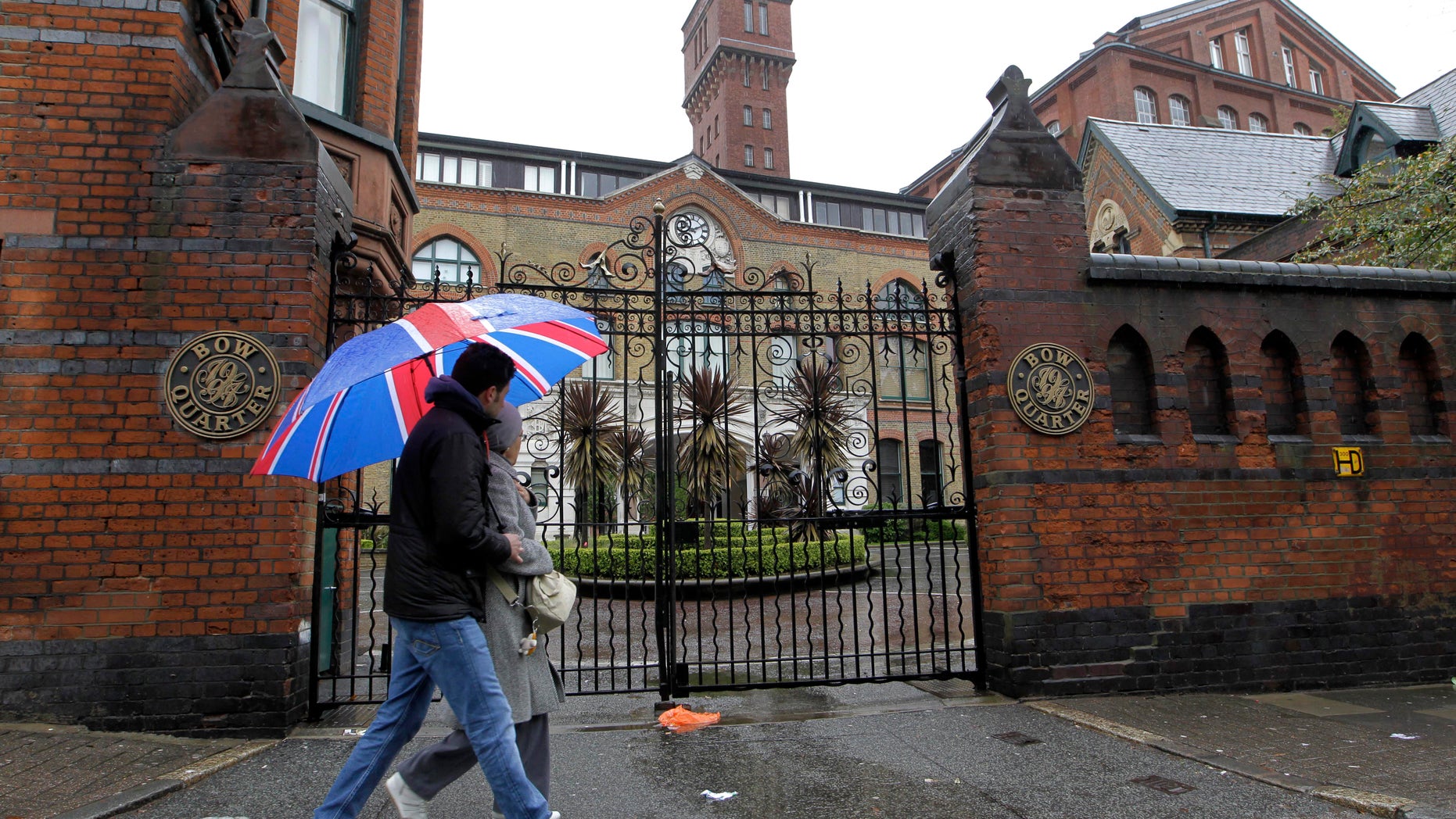 April 29, 2012: People walk past gated residential flats in Bow, east London, where the Ministry of Defence have warned residents that surface-to-air missiles could be stationed on their rooftops during the London Olympics, 2012.