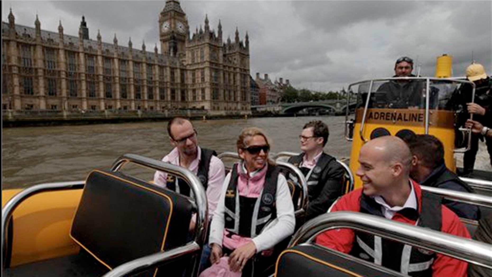 July 4, 2012: People are seen aboard a high-speed 12-seater rigid inflatable boat, run by the Protection Services International company as it travels past the Palace of Westminster on London's river Thames.