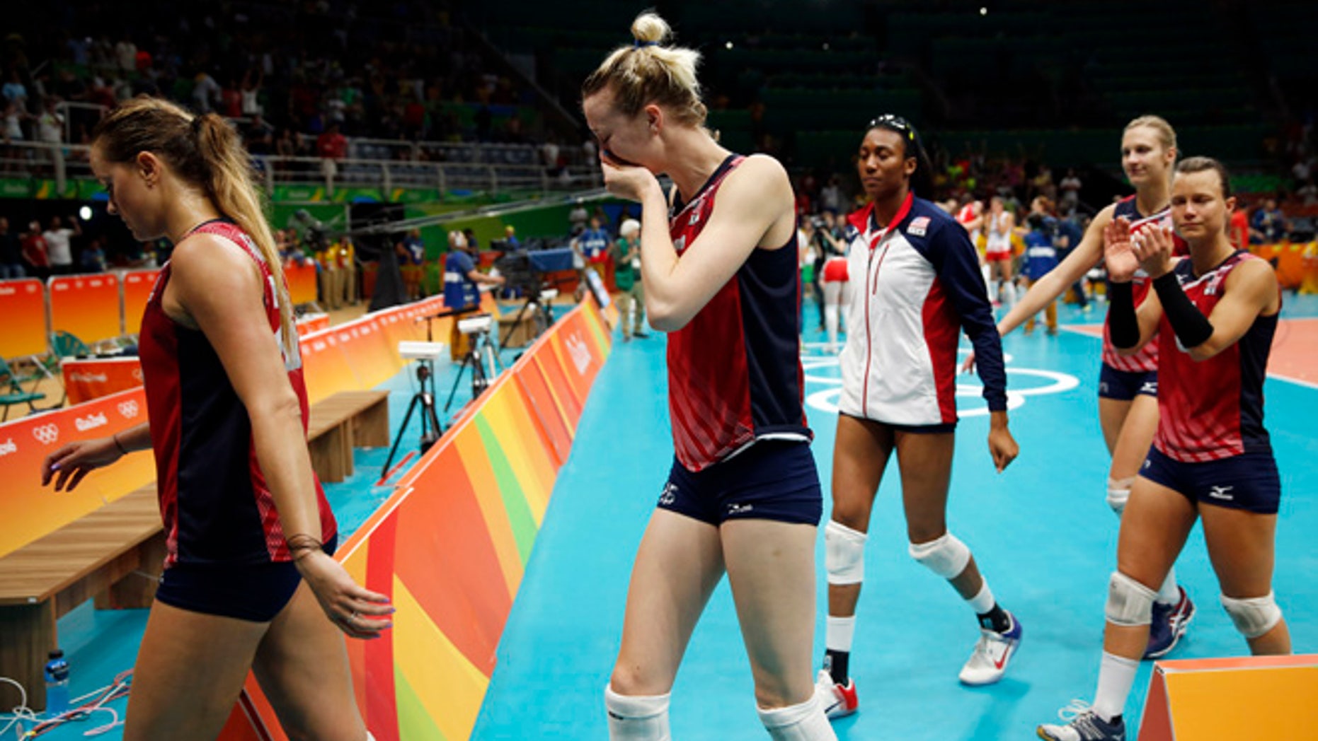 Members of the United States team walk off the court after losing a women's semifinal volleyball match against Serbia at the 2016 Summer Olympics in Rio de Janeiro, Brazil, Thursday, Aug. 18, 2016. (AP Photo/Matt Rourke)