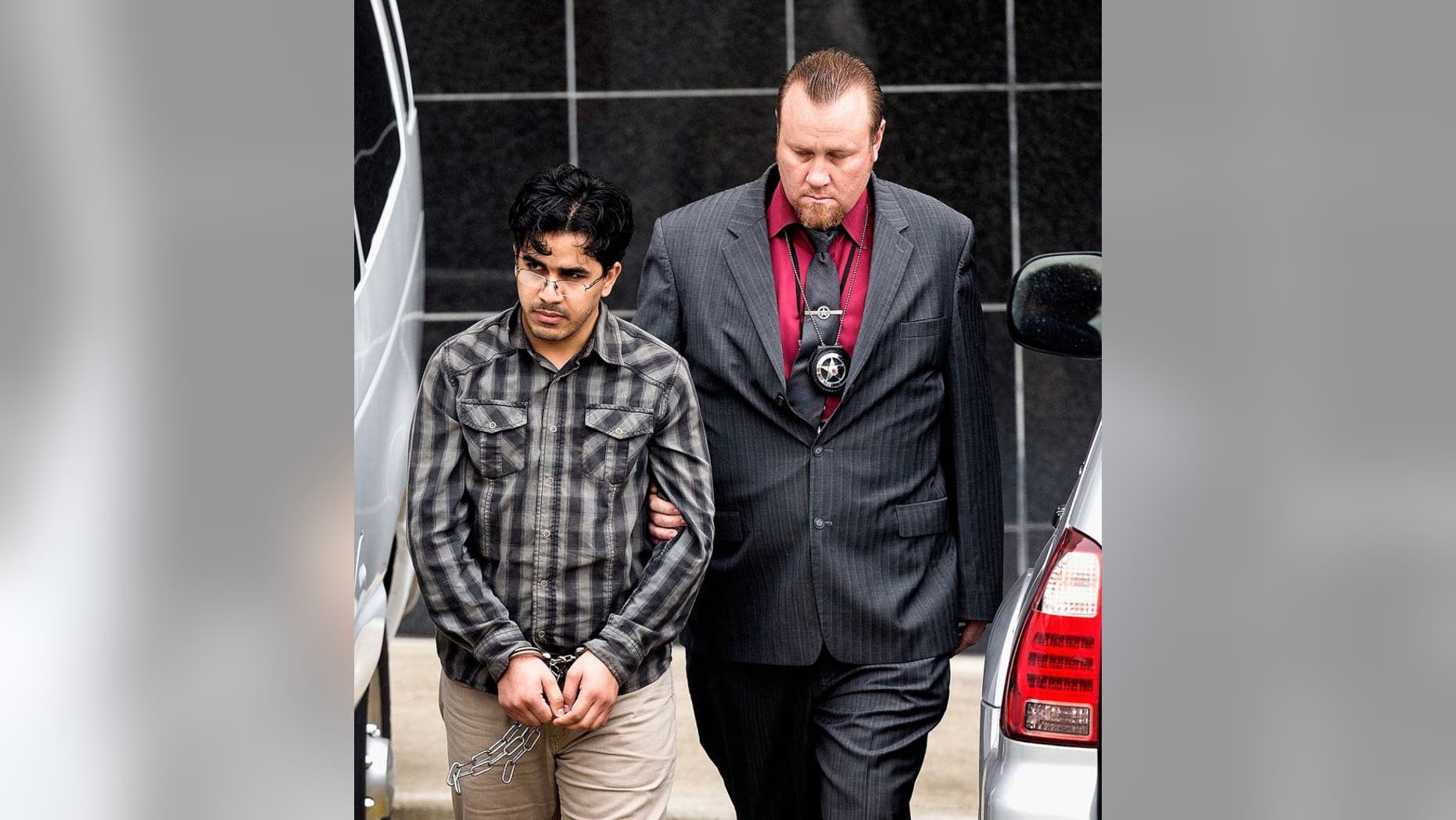 Omar Faraj Saeed Al Hardan, left, is escorted by U.S. Marshals from the Bob Casey Federal Courthouse on Friday, Jan. 8, 2016, in Houston.