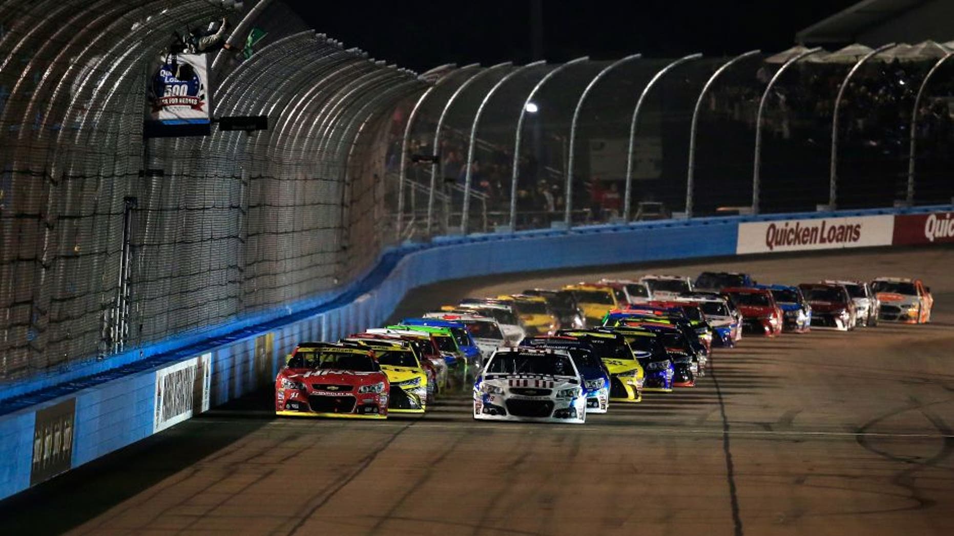 AVONDALE, AZ - NOVEMBER 15: Jimmie Johnson, driver of the #48 Lowe's Patriotic Chevrolet, and Kurt Busch, driver of the #41 Haas Automation Chevrolet, lead the field to the green flag at the start of the NASCAR Sprint Cup Series Quicken Loans Race for Heroes 500 at Phoenix International Raceway on November 15, 2015 in Avondale, Arizona. (Photo by Chris Trotman/Getty Images)