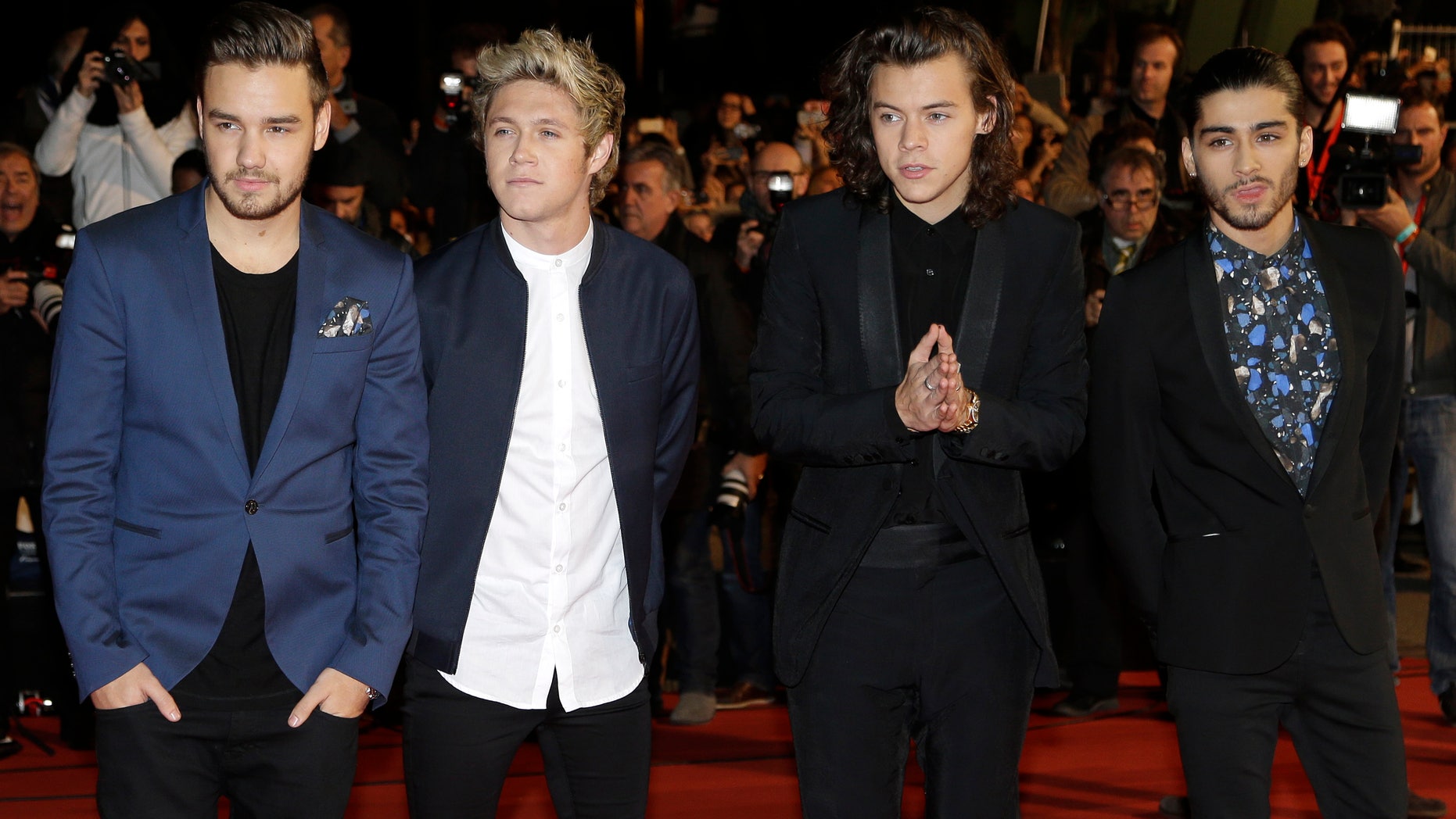 FILE - In this Dec. 13, 2014, photo, English Irish pop boy band One Direction arrives at the Cannes festival palace, to take part in the NRJ Music awards ceremony, in Cannes, southeastern France. The Philippine Bureau of Immigration is requiring two members of the English-Irish band One Direction to post bonds worth nearly $5,000 each, to be forfeited if they are caught using or impliedly promoting illegal drugs while in Manila for their concerts during the weekend of March 21-22, 2015. (AP Photo/Lionel Cironneau, File)