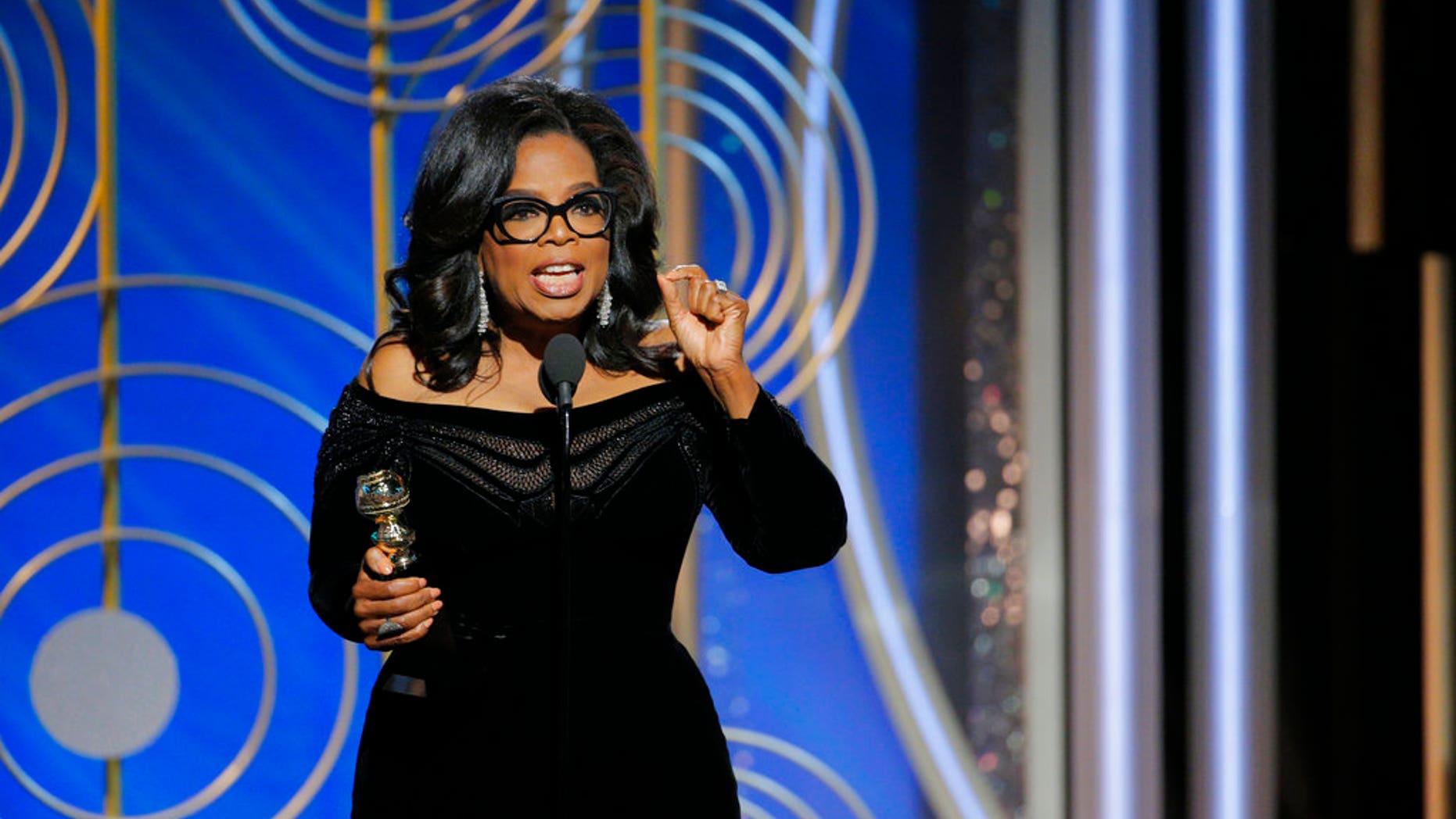 This image released by NBC shows Oprah Winfrey accepting the Cecil B. DeMille Award at the 75th Annual Golden Globe Awards in Beverly Hills, Calif., on Sunday, Jan. 7, 2018. (Paul Drinkwater/NBC via AP)