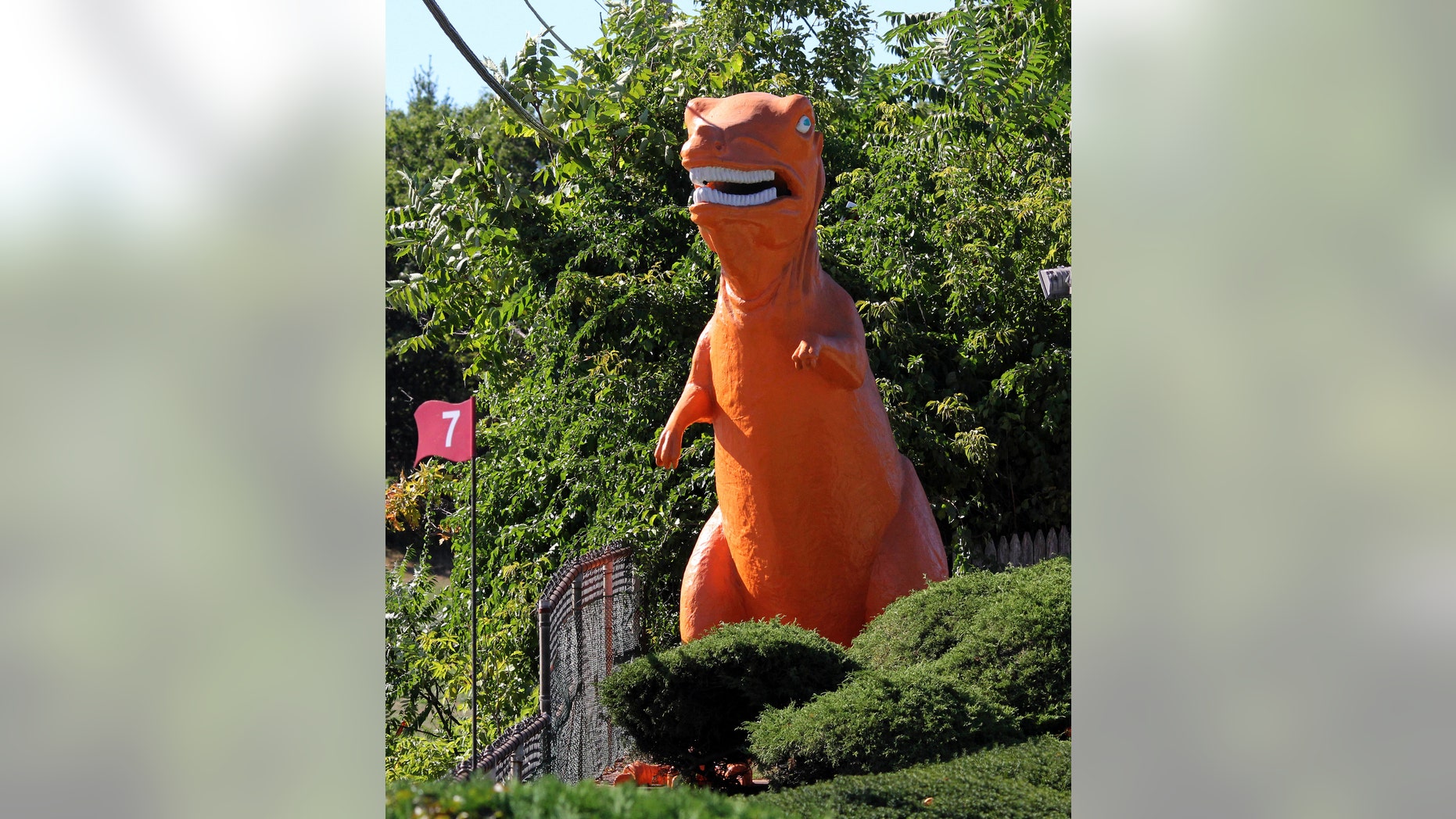 In this Monday, Sept. 12, 2016 photo, a 20-foot-high orange dinosaur stands near Route 1 in Saugus, Mass. Some feared the 20-foot dinosaur would disappear because the miniature golf course on which it has stood since 1958 was sold to a developer.