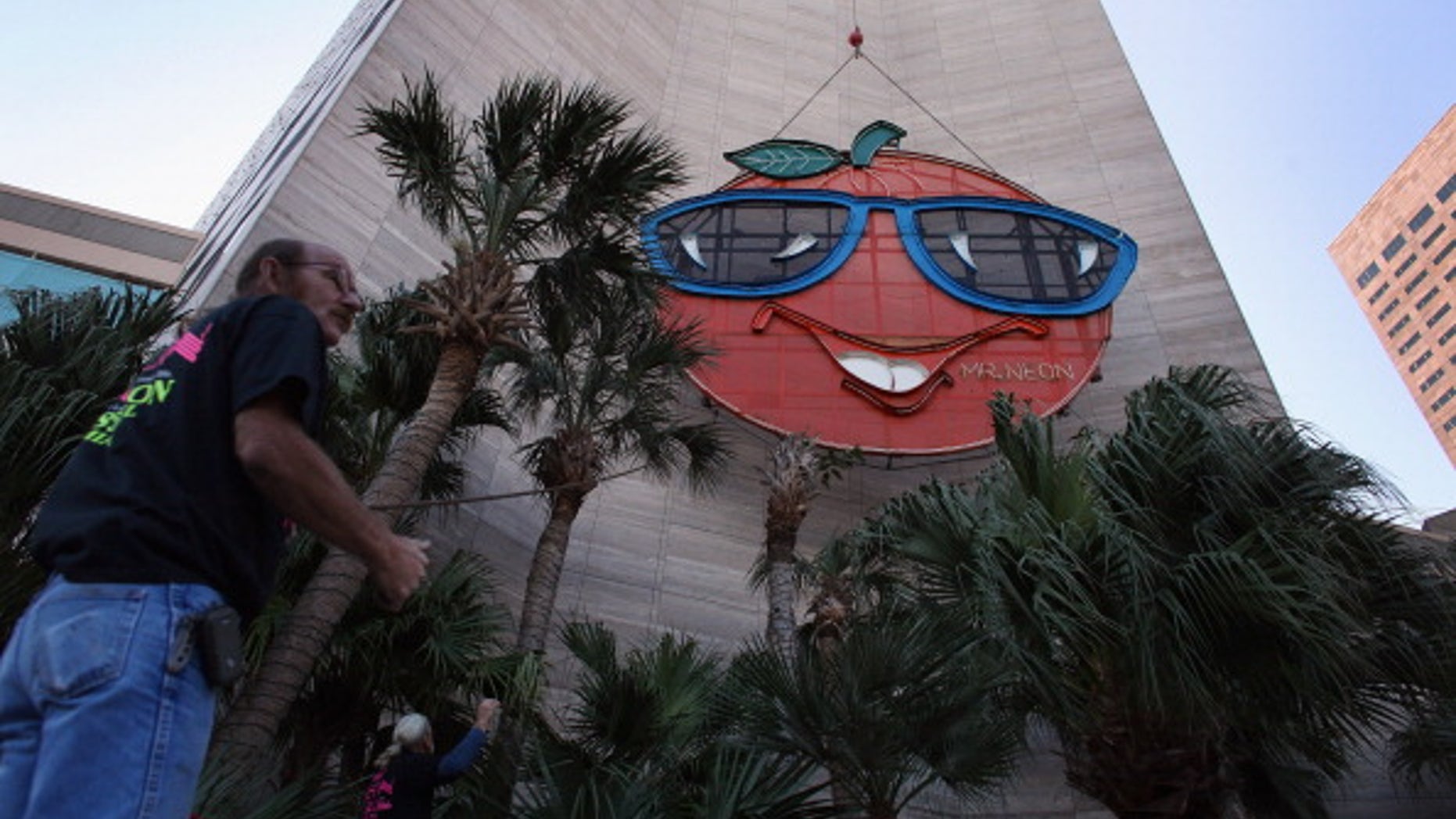 Bill Flaherty from Mr. Neon inc. helps place the Big Orange New Year's time ball onto the side of the Hotel Intercontinental in Miami, Florida.