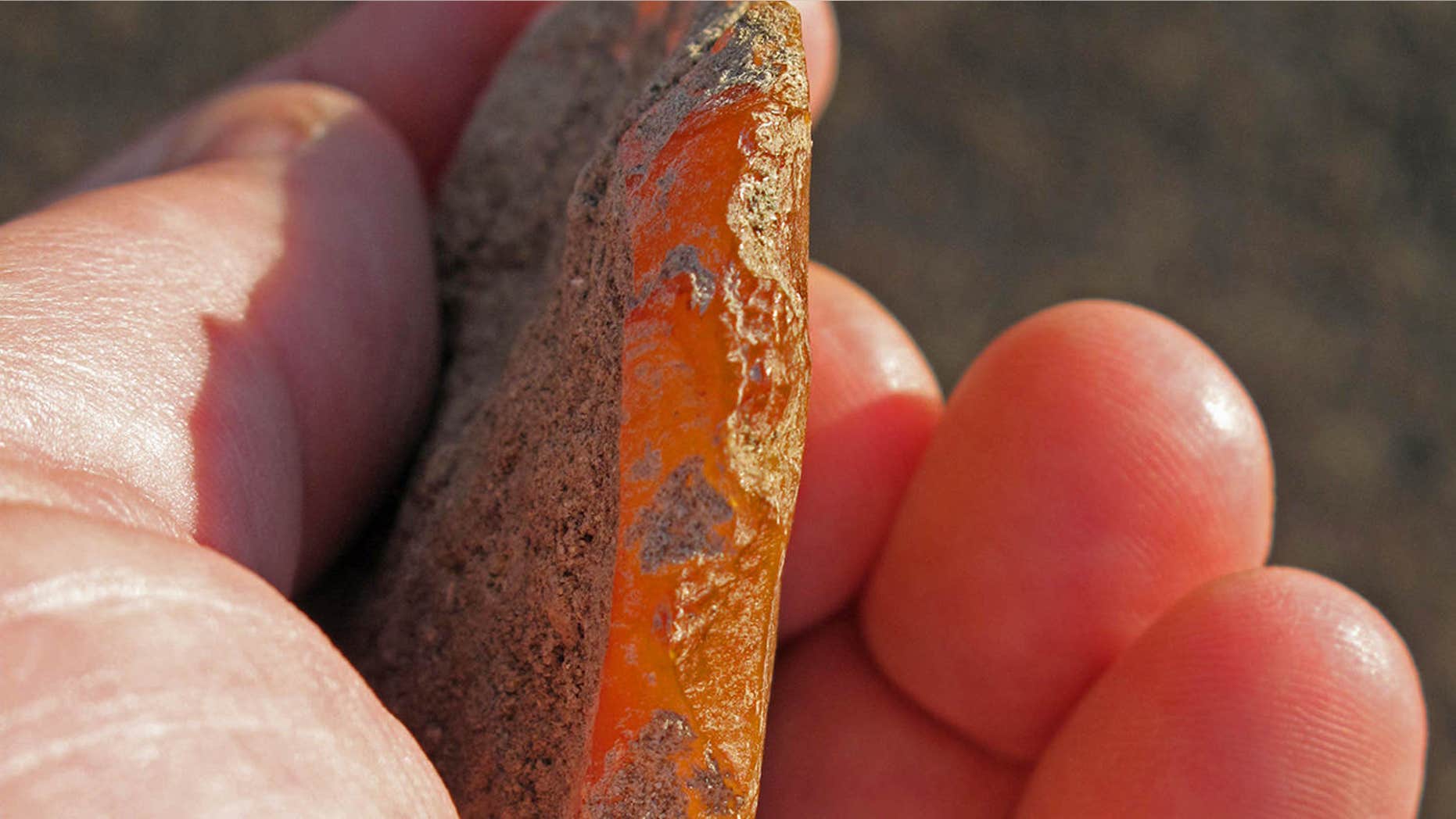 This undated photo provided by the University of Oregon Museum of Natural and Cultural History shows a scraper chipped out of agate found at an ancient rock shelter in the high desert of eastern Oregon.