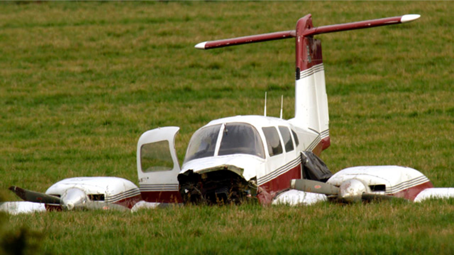 Oct. 26, 2011: A Beechcraft V35 plane sits in the field where it made an emergency landing late Tuesday after colliding with another plane in Wilsonville, Ore.