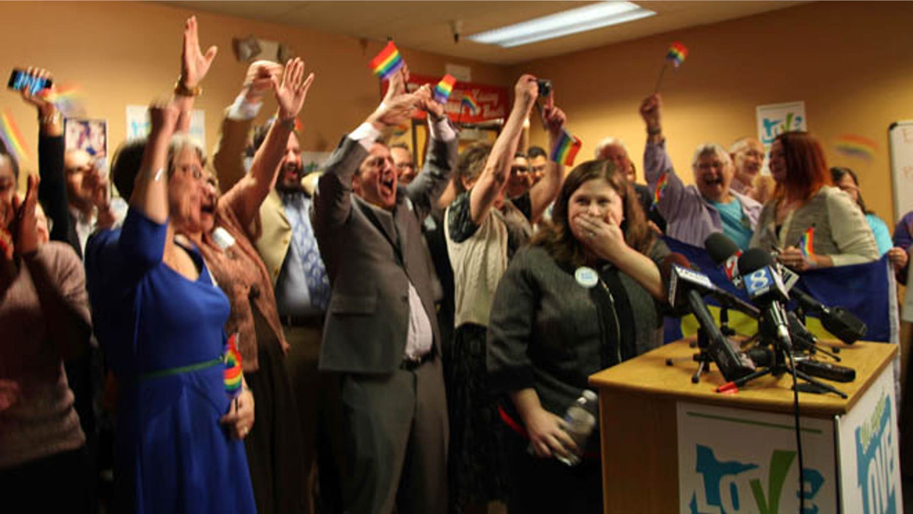 May 19, 2014: Gay and lesbian couples and their supporters react to the news of a federal judge striking down Oregon's ban on same-sex marriage, in Portland, Ore.