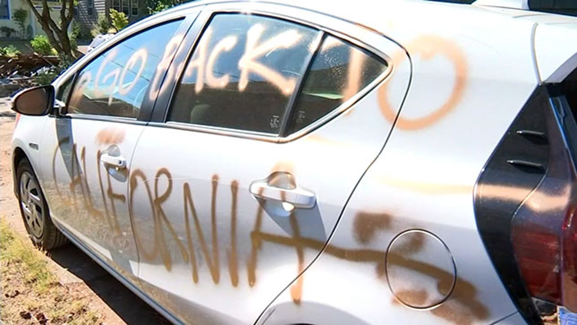 A California couple turned Portlanders said their home and car were spray-painted hours after a road rage incident.