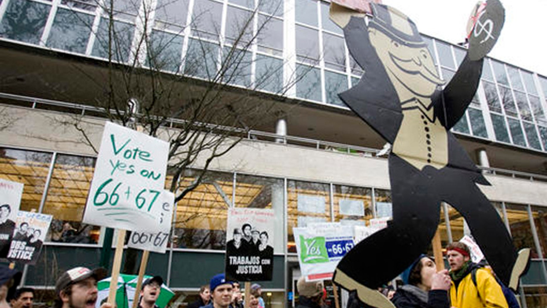 In this Jan. 22, 2010 file photo, supporters of Oregon's Measures 66 and 67, designed to raise taxes on high-income earners and corporations, hold a rally in Portland, Ore.