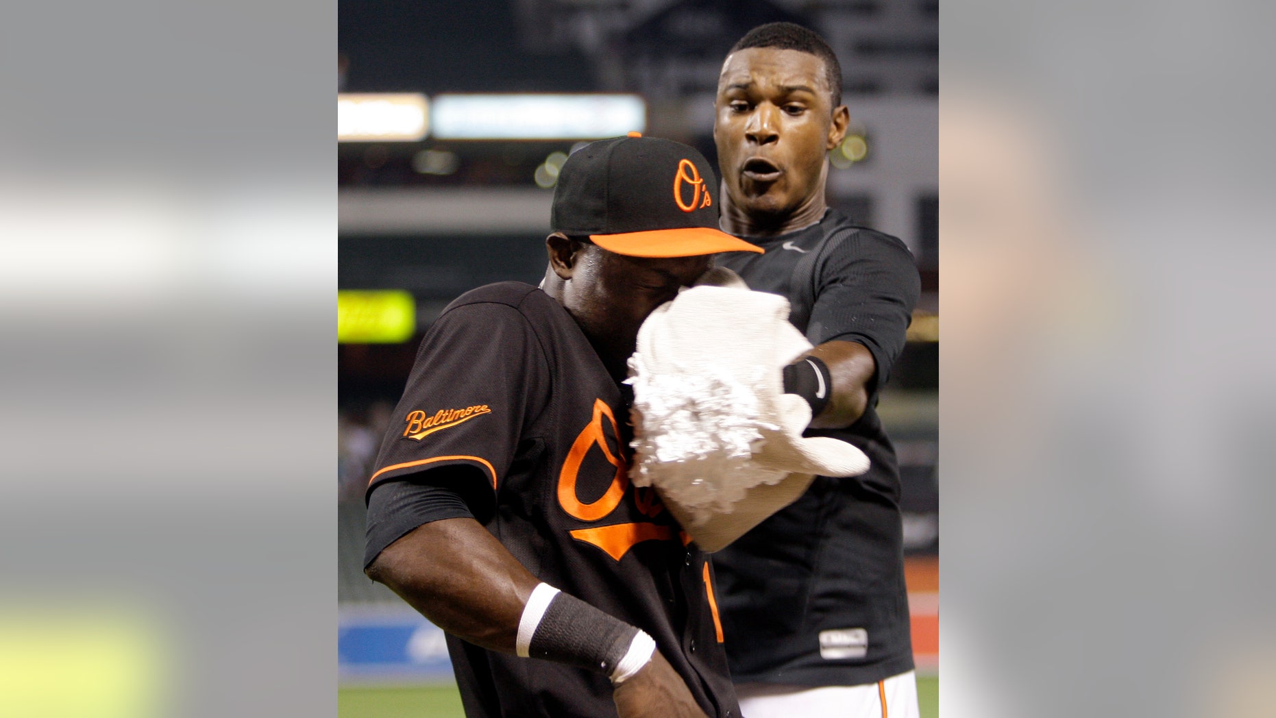 Felix Pie, left, is hit in the face with a shaving cream pie by Orioles teammate Adam Jones.