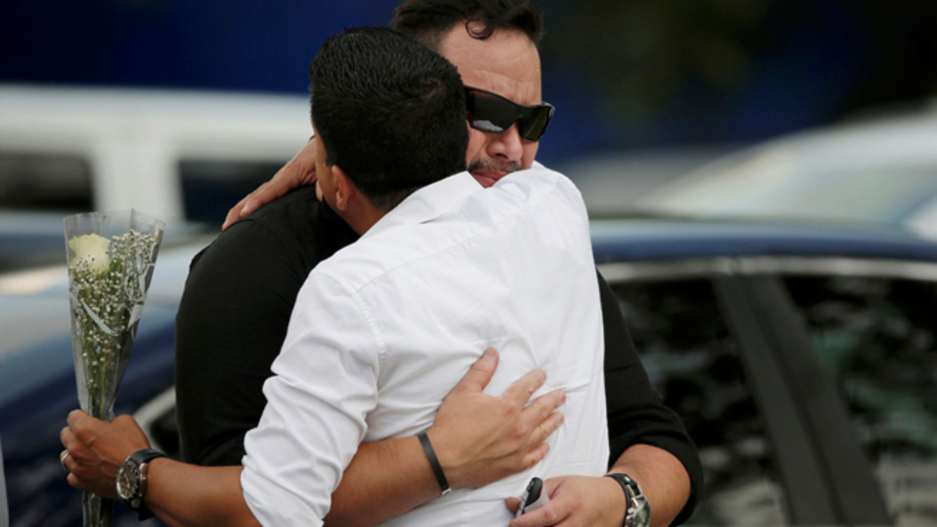 Mourners embrace outside the wake for Pulse shooting victim Javier Jorge Reyes in Orlando, Florida, U.S. June 15, 2016