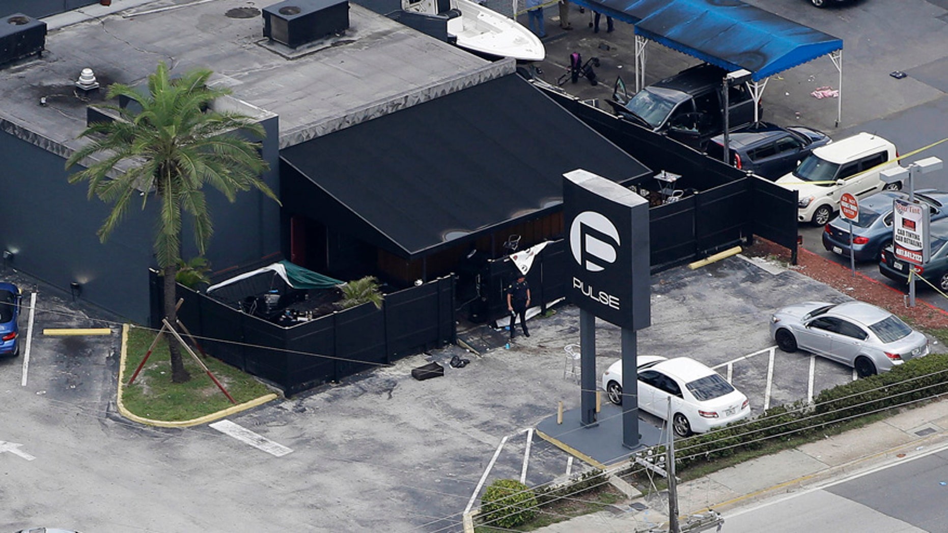 In this June 12, 2016 file photo, law enforcement officials work at the Pulse nightclub in Orlando, Fla., following a mass shooting.