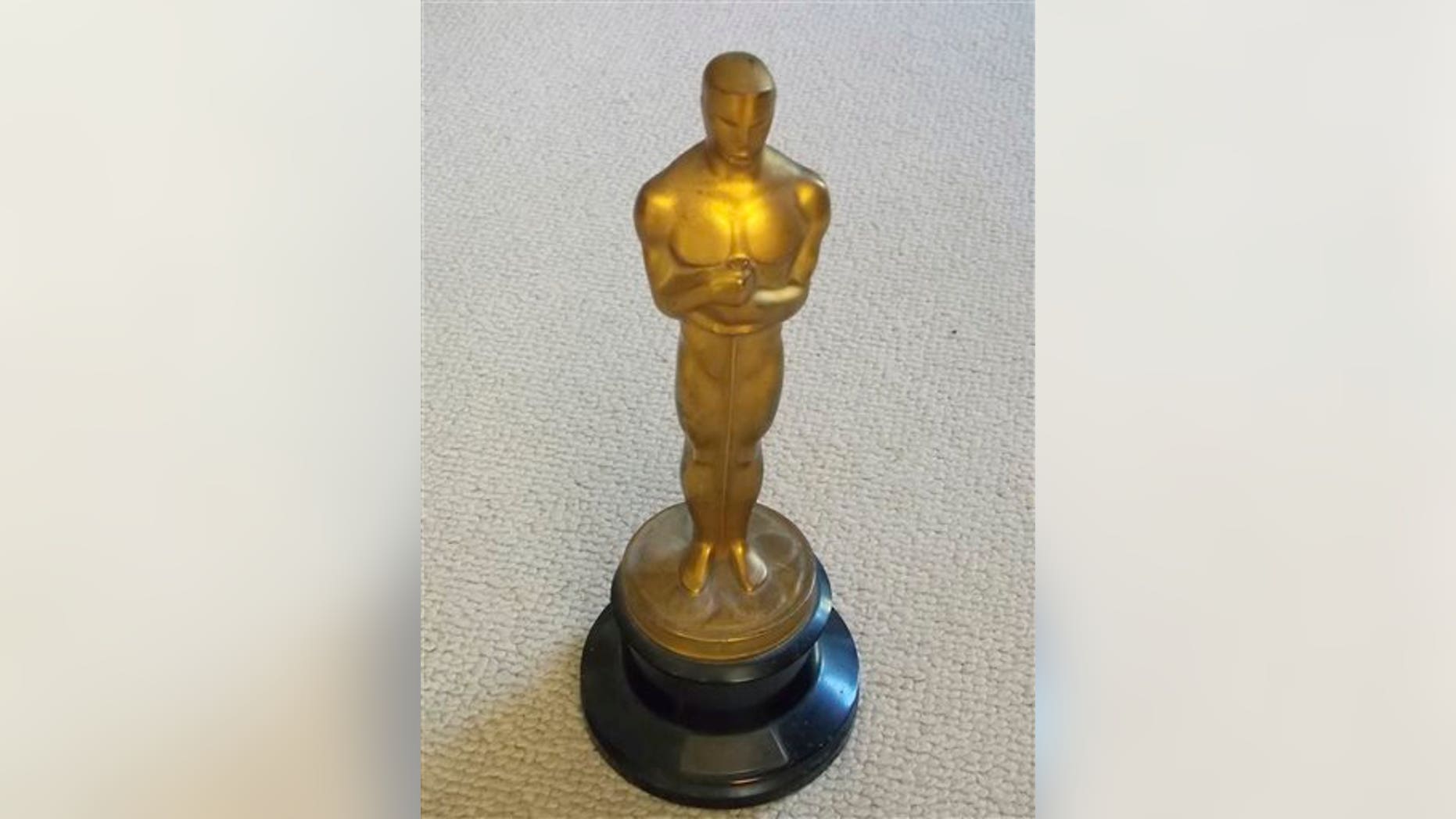 This undated photo released by Briarbrook Auctions shows an Academy Award Oscar statue awarded for color art direction in 1942 to Joseph C. Wright for his work on My Gal Sal.