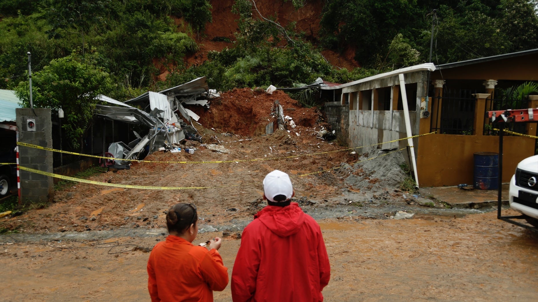 Civil Defense workers look the area where a couple was killed after their home was destroyed by a mudslide in Arraijan on the outskirts of Panama City, Tuesday, Nov. 22, 2016. Civil defense officials in Panama say the country has already seen three deaths blamed on late-season Tropical Storm Otto. (AP Photo/Arnulfo Franco)
