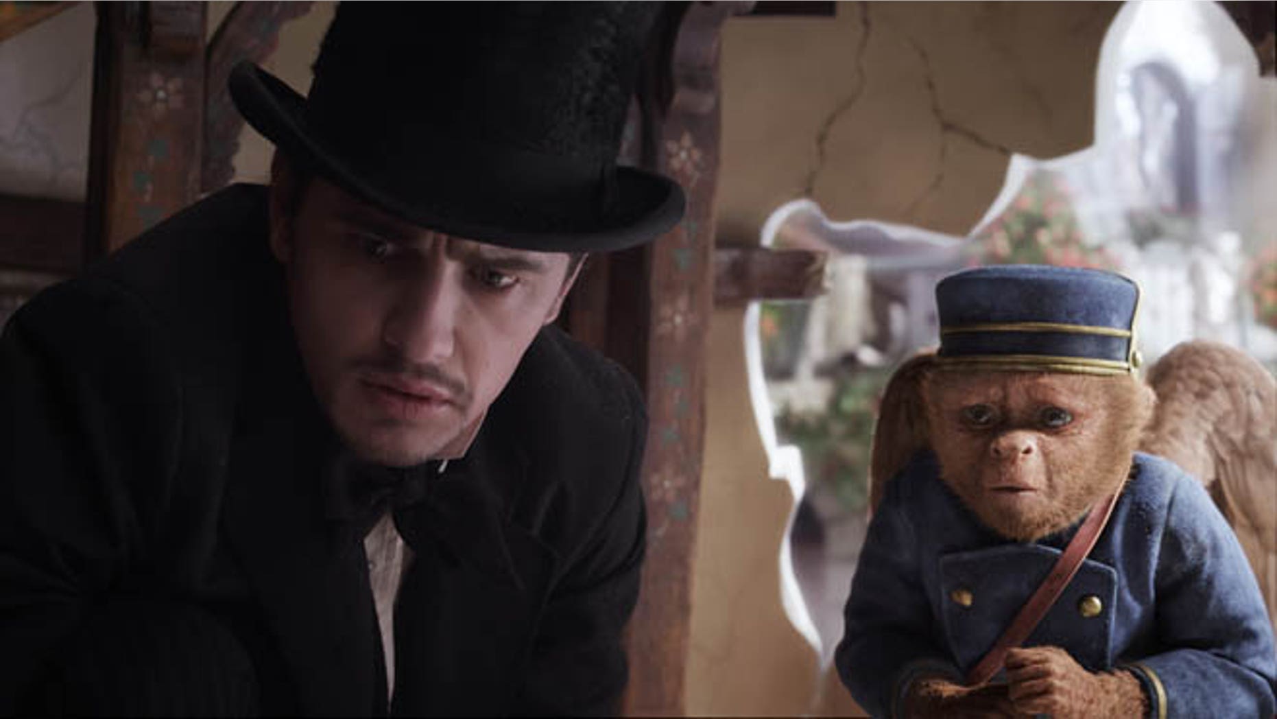 This file film image provided by Disney Enterprises shows James Franco, as Oz, left, and the character Finley, voiced by Zach Braff, in a scene from "Oz the Great and Powerful." Oz the Great and Powerful is living up to its name at the box office. Walt Disney's 3-D blockbuster has led all films for the second week in a row, taking in $42.2 million according to studio estimates.