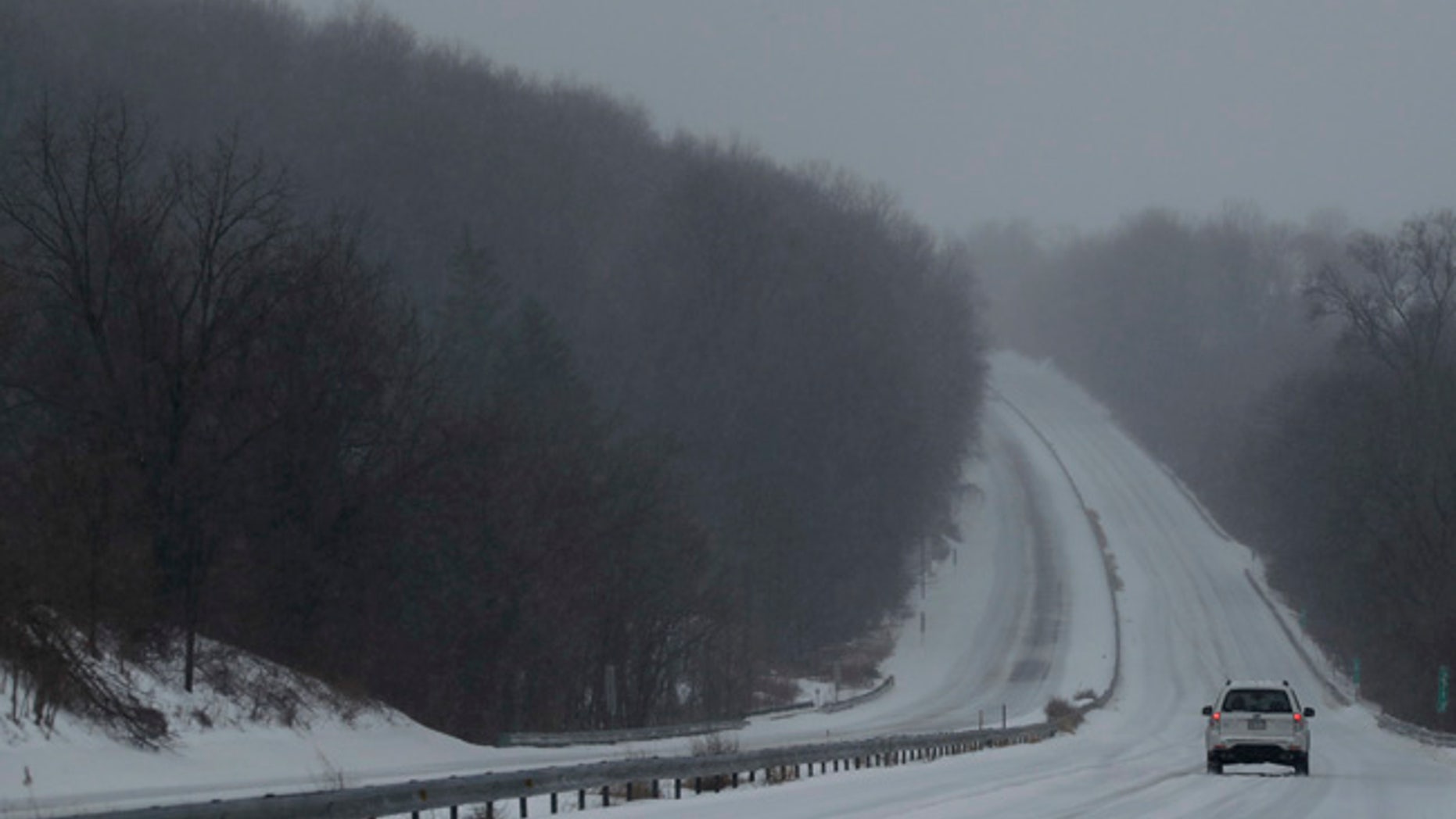 A car drives down US 30 through a winter snow storm, Tuesday, March 14, 2017, in Valley Township, Pa. (AP Photo/Matt Slocum)