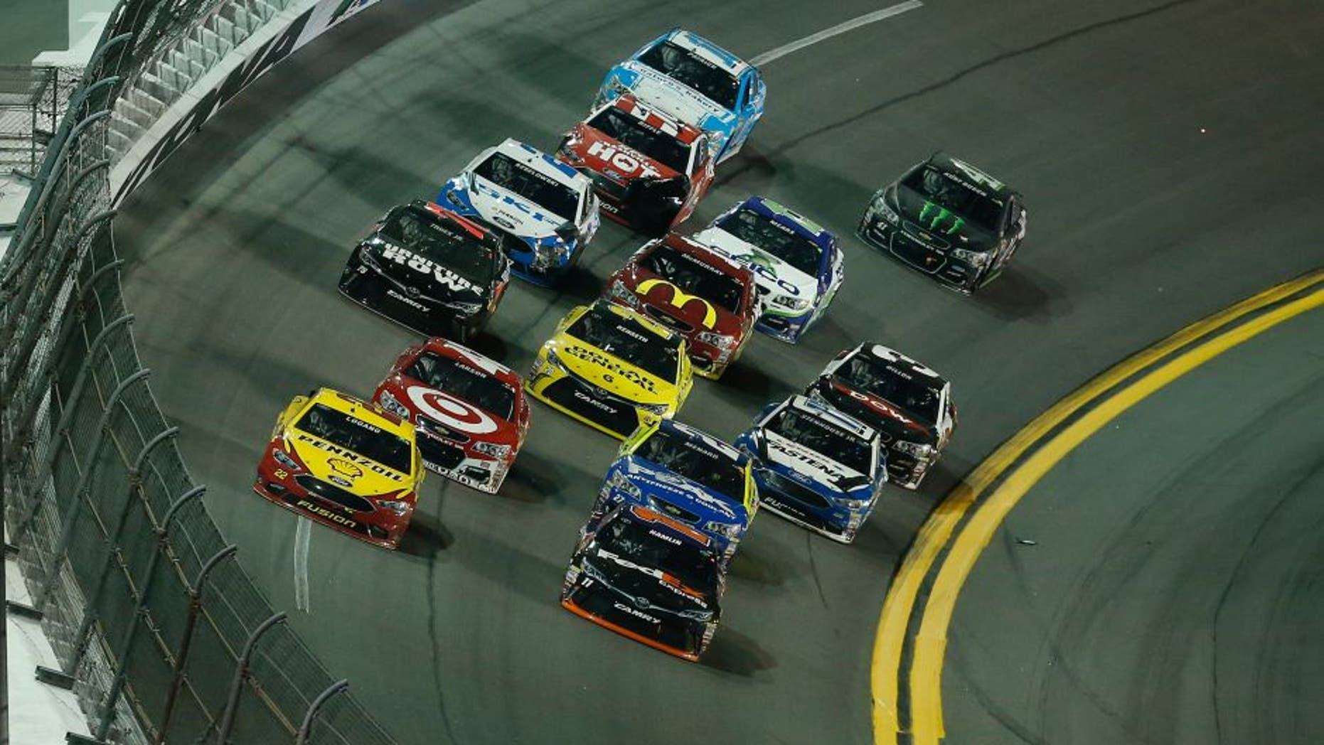 DAYTONA BEACH, FL - FEBRUARY 13: Denny Hamlin, driver of the #11 FedEx Express Toyota, and Joey Logano, driver of the #22 Shell Pennzoil Ford, lead a pack of cars during the NASCAR Sprint Cup Series Sprint Unlimited at Daytona International Speedway on February 13, 2016 in Daytona Beach, Florida. (Photo by Matt Sullivan/Getty Images)