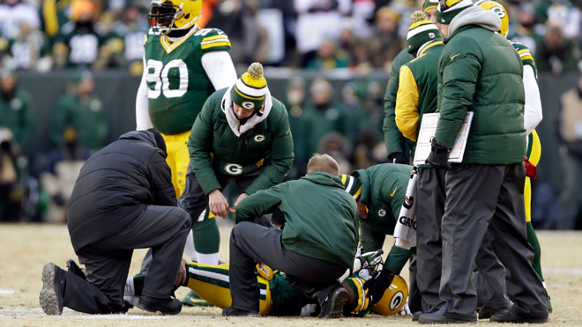 Jan. 5, 2014: Trainers check on Green Bay Packers cornerback Sam Shields (37) during the first half of an NFL wild-card playoff football game against the San Francisco 49ers in Green Bay, Wis.