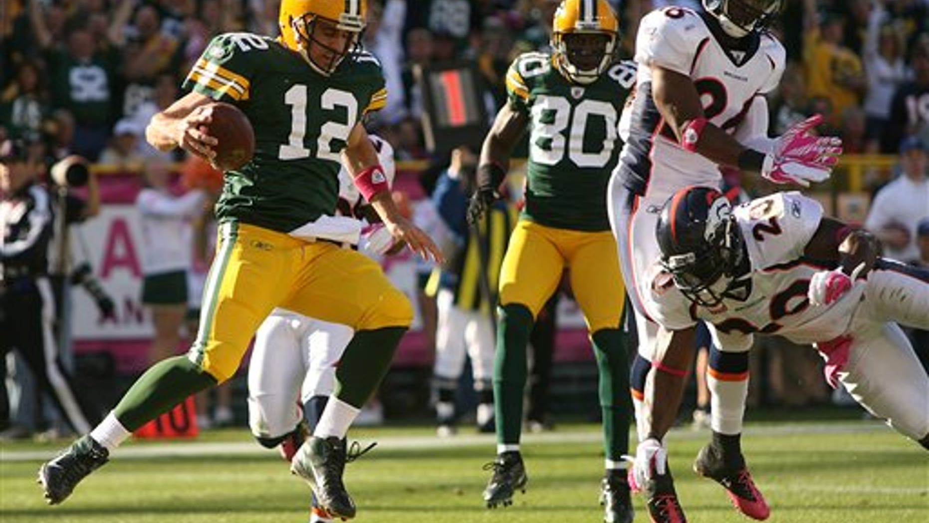Oct. 2: Green Bay Packers quarterback Aaron Rodgers (12) runs in for a touchdowns in the second quarter of an NFL football game against the Denver Broncos at Lambeau Field in Green Bay, Wis.