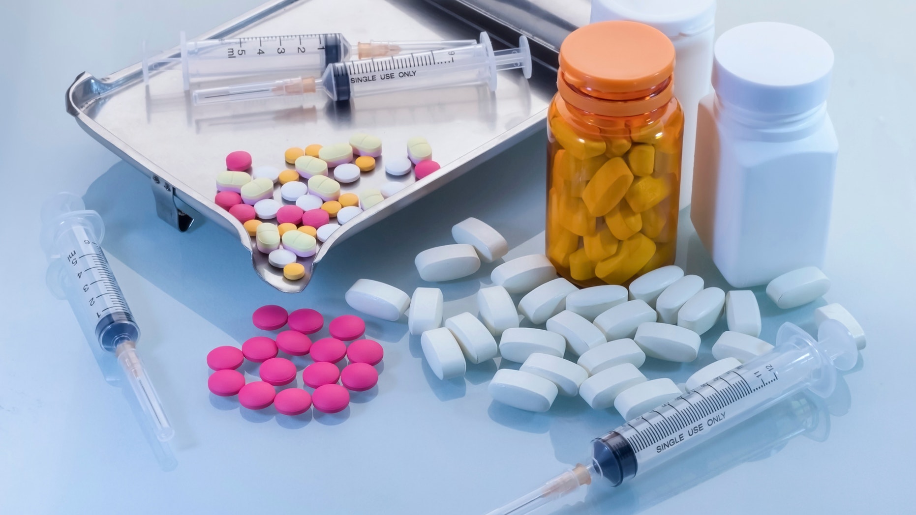 Medical background with pill, syringe, and bottles