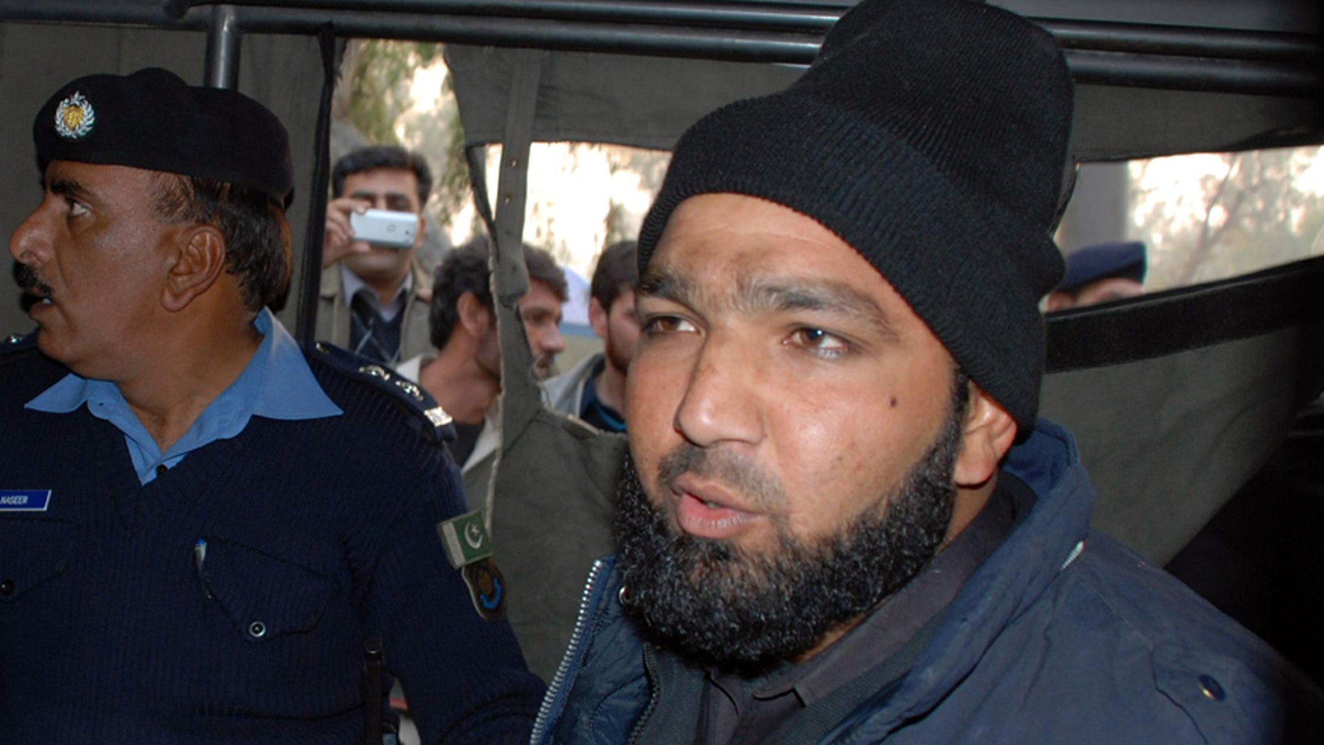 Jan. 4, 2011: Commando of Pakistan's Elite force Mumtaz Qadri, right, who killed Punjab's Gov. Salman Taseer, sits in police custody in Islamabad, Pakistan.
