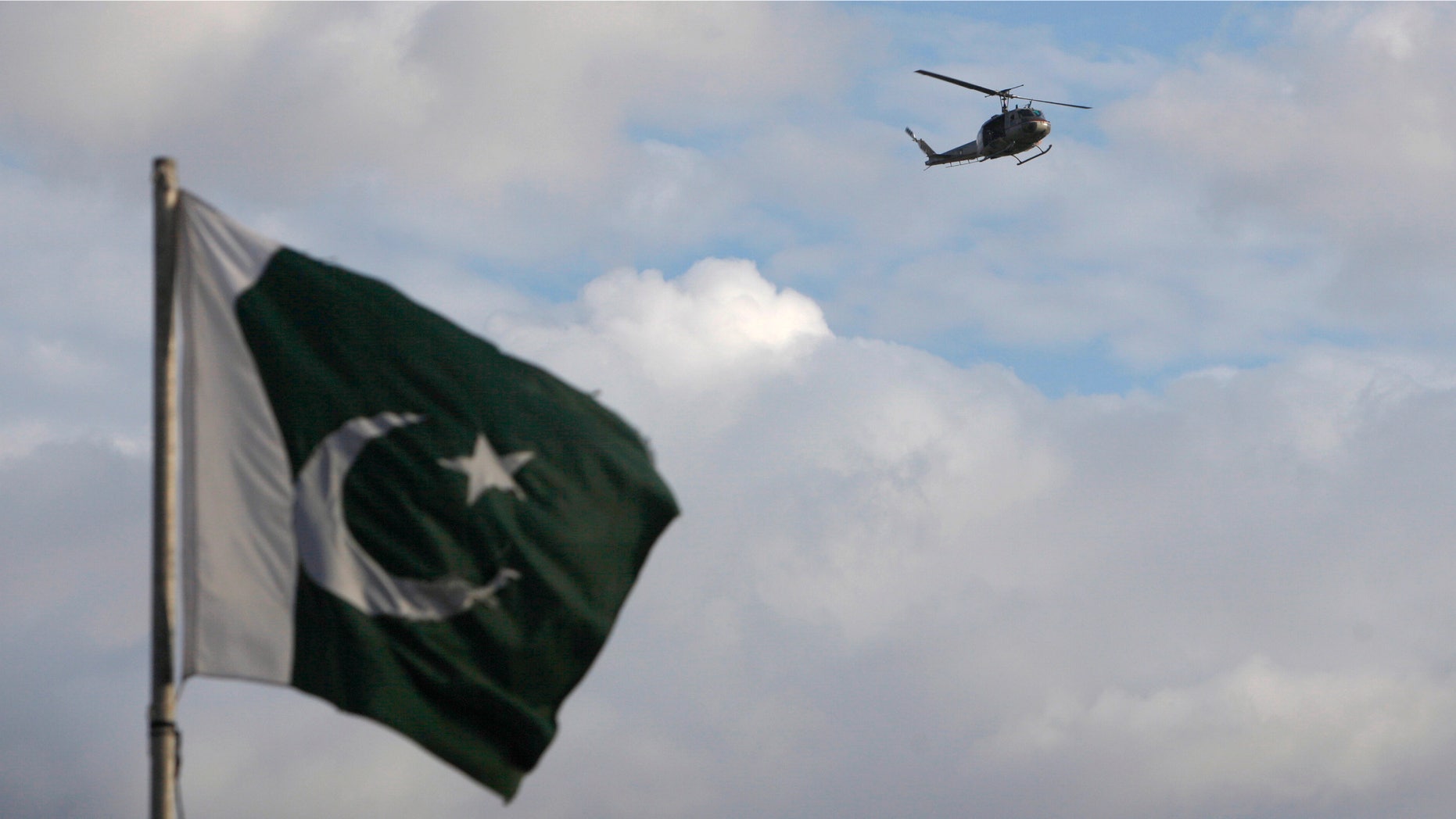 Sept. 2, 2014: A helicopter flies past a Pakistan's national flag in the premises of parliament house during the Revolution March in Islamabad