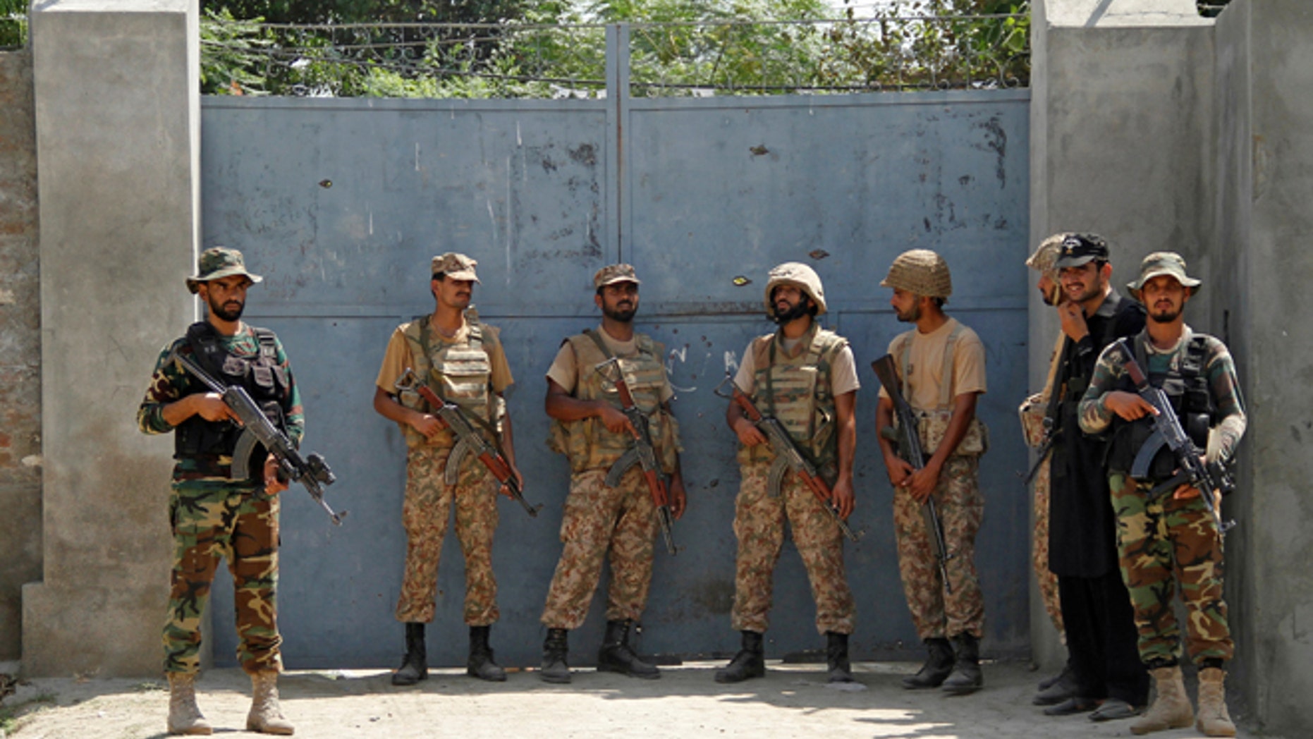 Pakistan Army soldiers stand guard at an entrance gate, after suicide bombers attacked a Christian neighborhood in Khyber Agency near Peshawar, Pakistan, September 2, 2016.