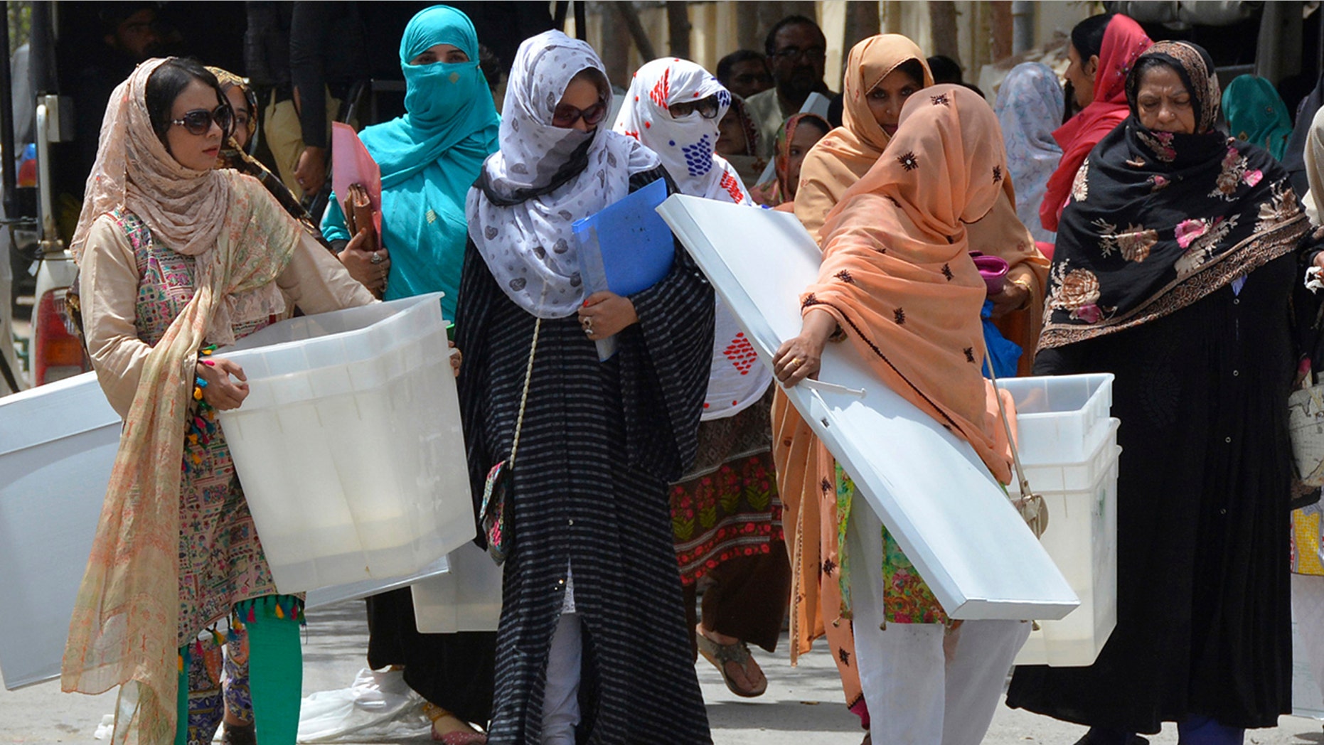 Pakistani election workers collect ballot boxes and polling material from a distribution center in Quetta, Pakistan, Tuesday, July 24, 2018.