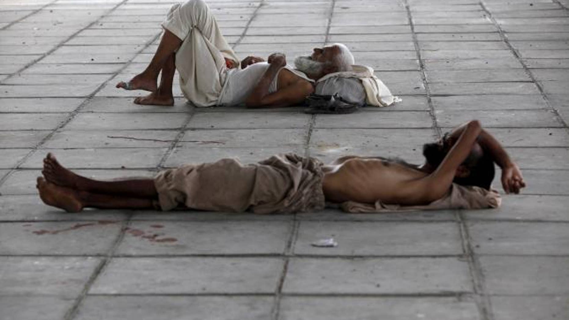 June 22, 2015: Men sleep in shade under a bridge during intense hot weather in Karachi, Pakistan.