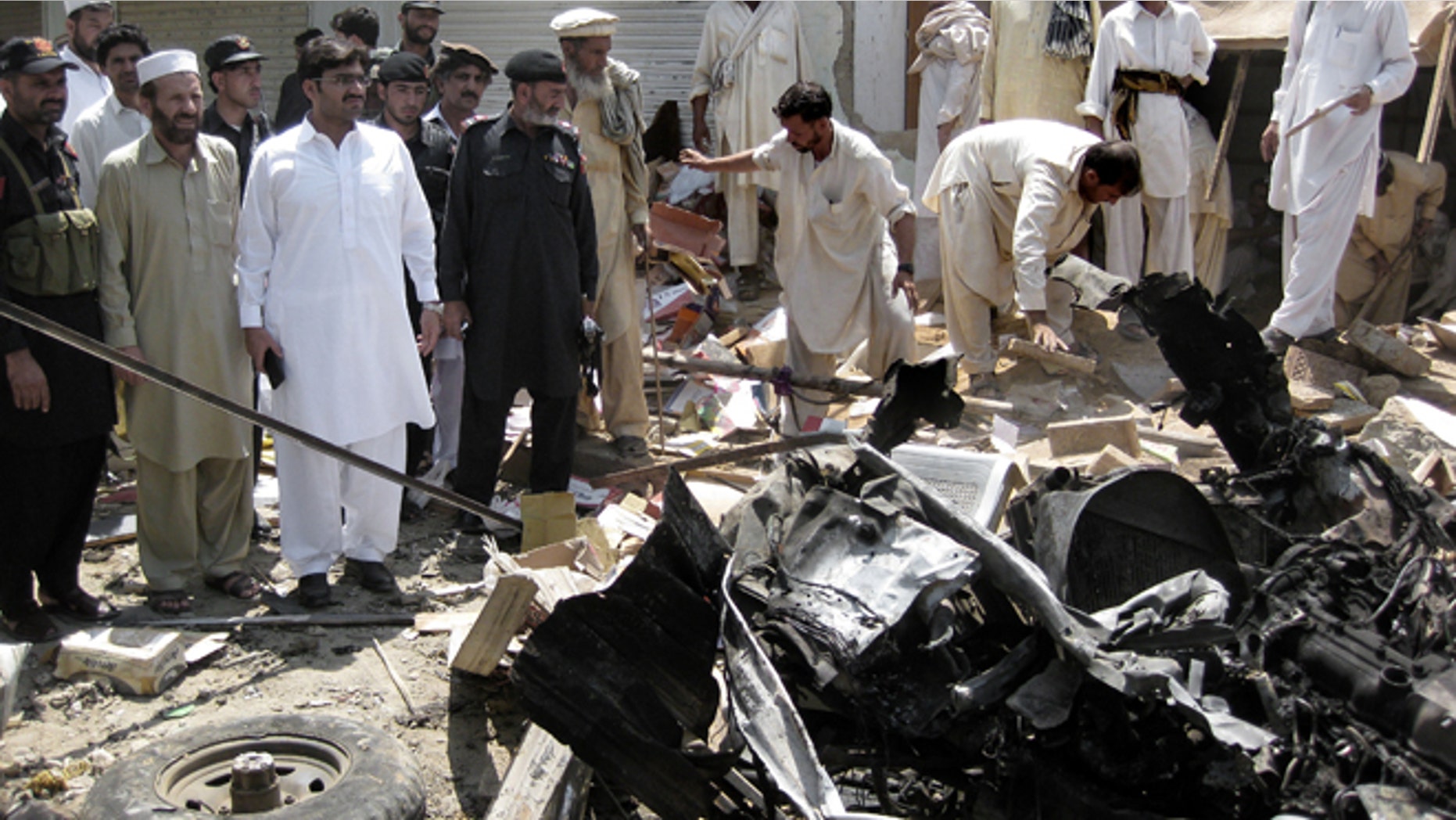 FILE: July 26, 2012: Pakistani investigators look for evidence at the site of a bomb blast in the Pakistani tribal area of Khar, Bajur.