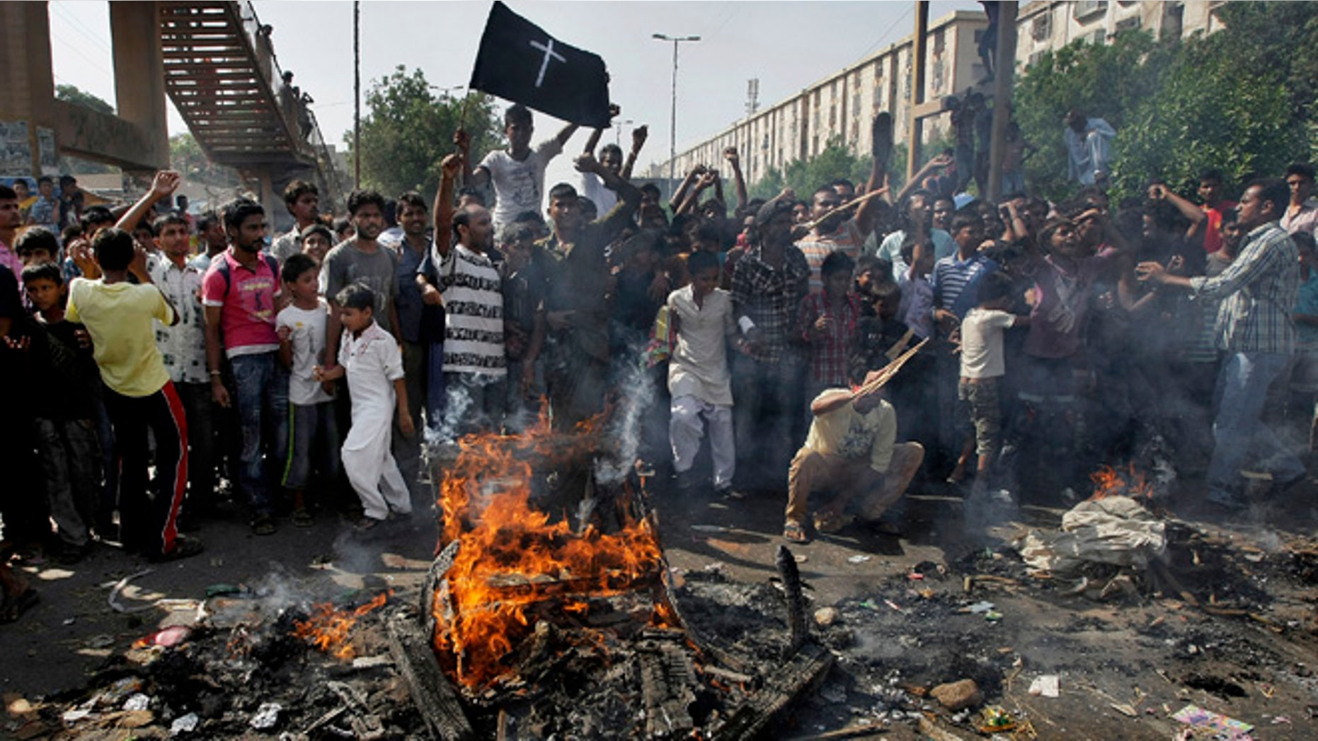 Sept. 22, 2013: Pakistani Christians chant slogans as they burn materials during a protest against a suicide attack on a church in Karachi, Pakistan. A suicide bomb attack on a historic church in northwestern Pakistan killed scores of people Sunday, officials said, in one of the worst assaults on the countrys Christian minority in years.