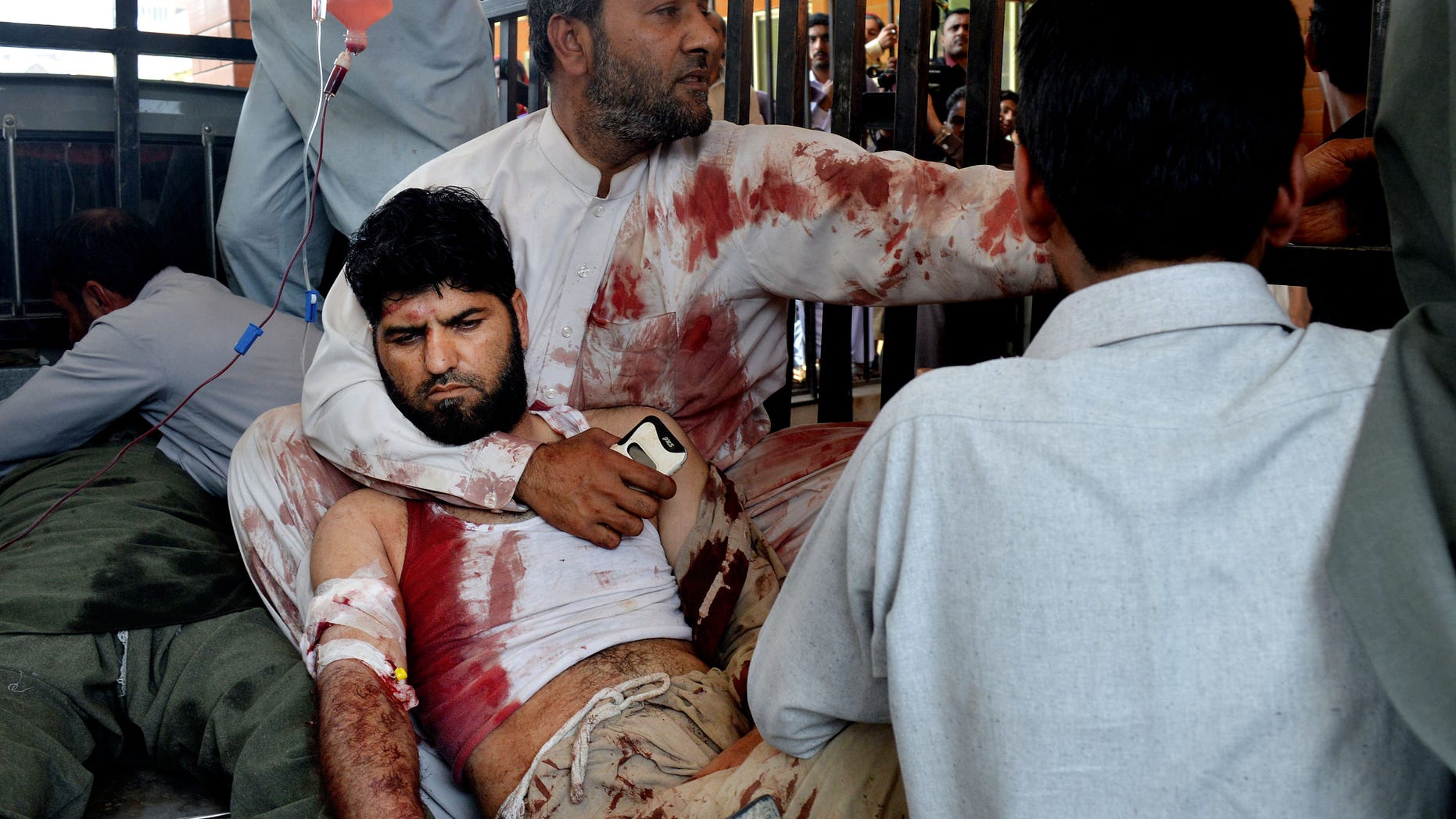 Volunteers carry an injured man to a hospital in Peshawar, Pakistan.