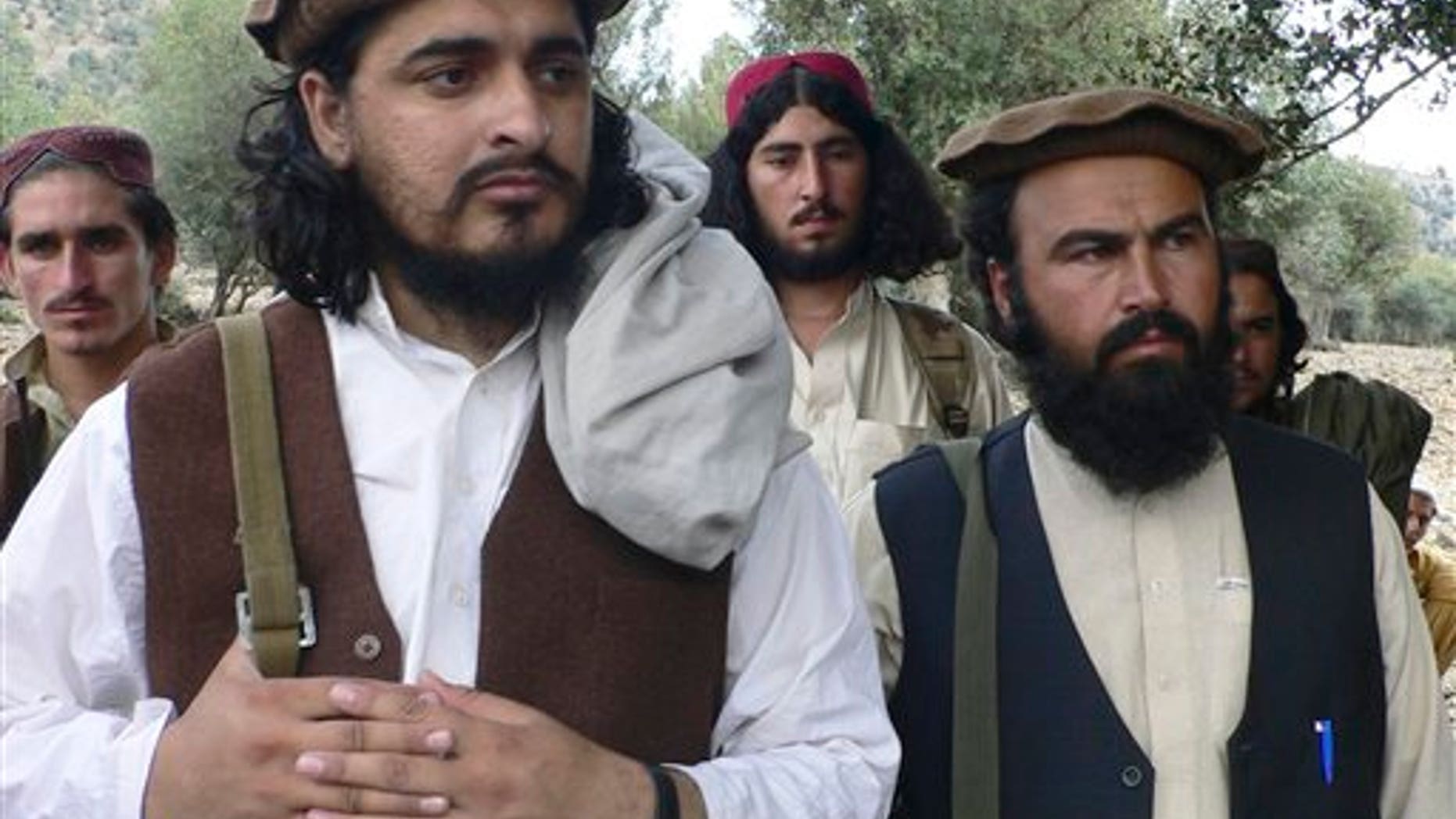 In this Sunday, Oct. 4, 2009 file photo, new Pakistani Taliban chief Hakimullah Mehsud, left, is seen with his comrade Waliur Rehman during his meeting with media in Sararogha of Pakistani tribal area of South Waziristan along the Afghanistan border. Prominent al-Qaida and Afghan Taliban fighters held recent meetings with Pakistani militants to ask them to set aside their differences and step up support for the battle against U.S.-led forces in Afghanistan, militant commanders said Monday, Jan. 2, 2012.