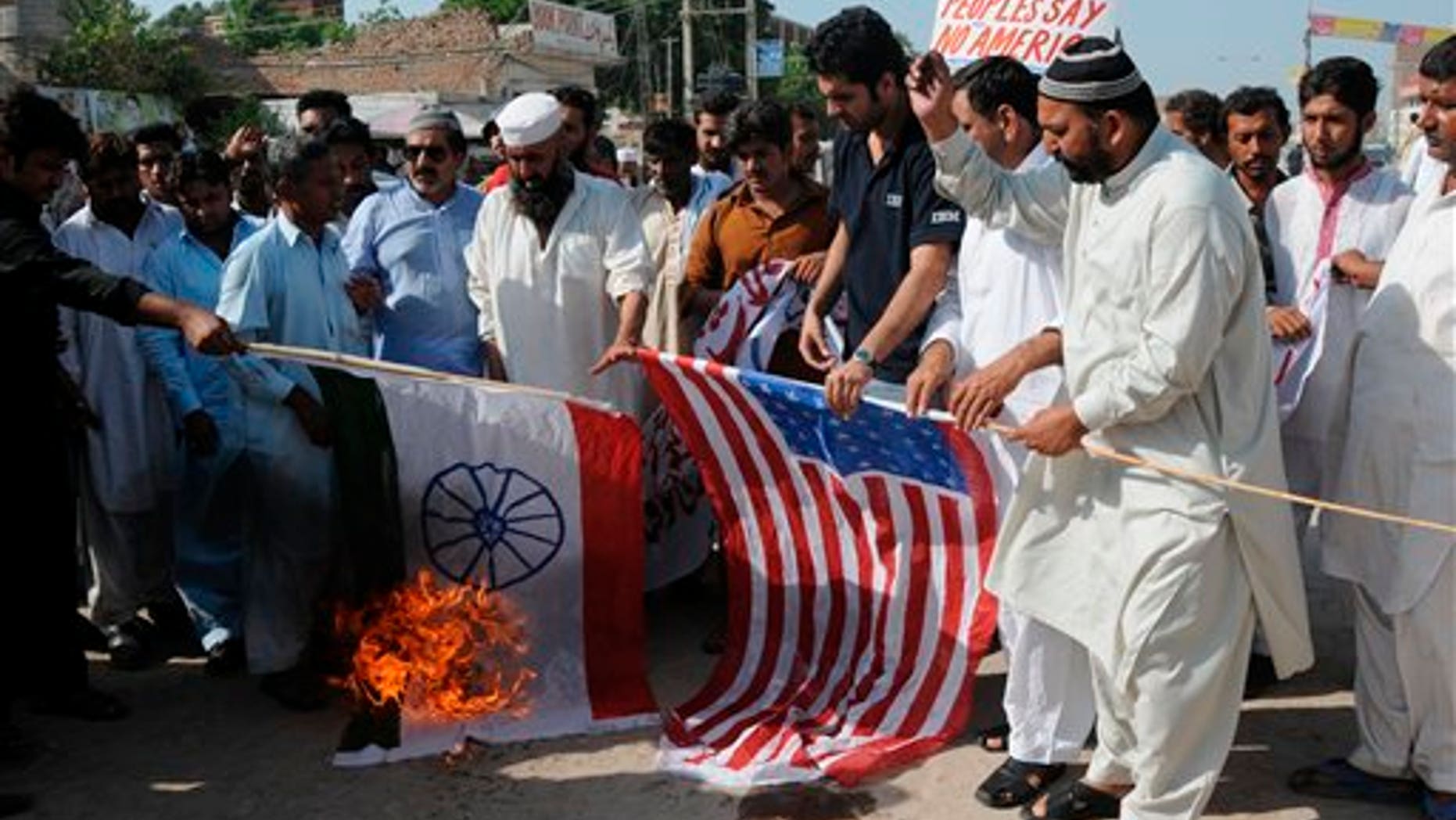 Sept. 23: Pakistani protesters burn representations of US and Indian flags at an anti-American rally in Multan, Pakistan. Pakistan lashed out at the U.S. for accusing the country's most powerful intelligence agency of supporting extremist attacks against American targets in Afghanistan - the most serious allegations against Islamabad since the beginning of the Afghan war.