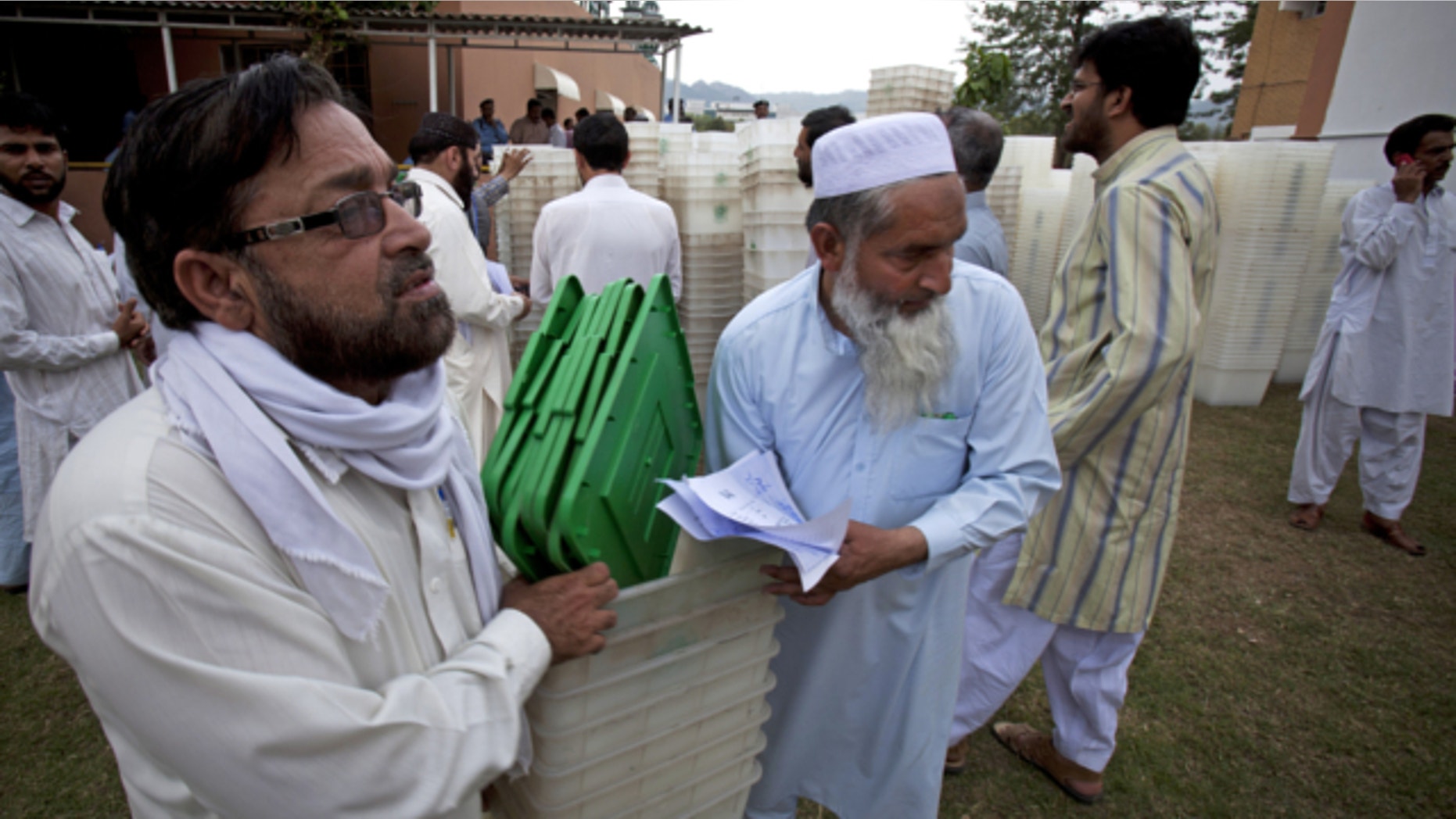 May 10, 2013: Pakistani election staff carry ballot boxes for tomorrow;s elections in Islamabad, Pakistan.