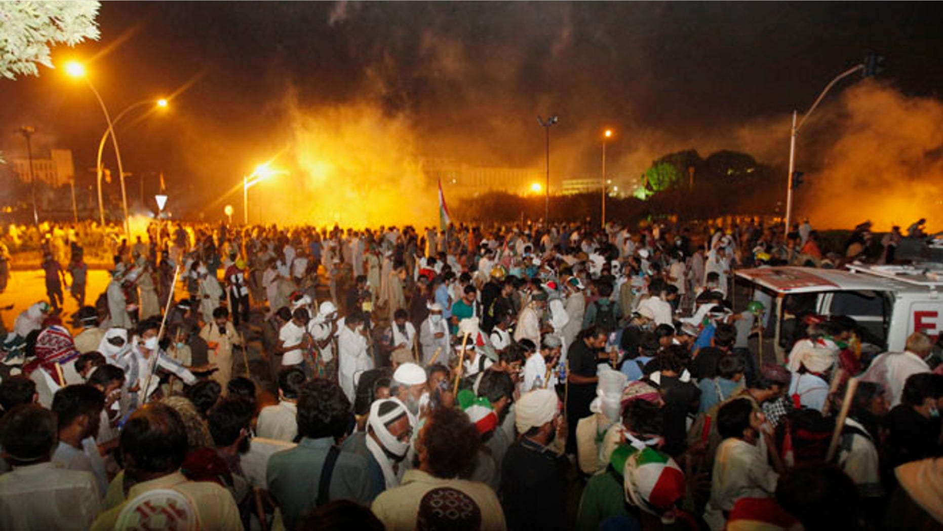 Aug 30, 2014: Pakistani protesters run after police fire tear gas during clashes near the prime minister's home in Islamabad, Pakistan. (AP)