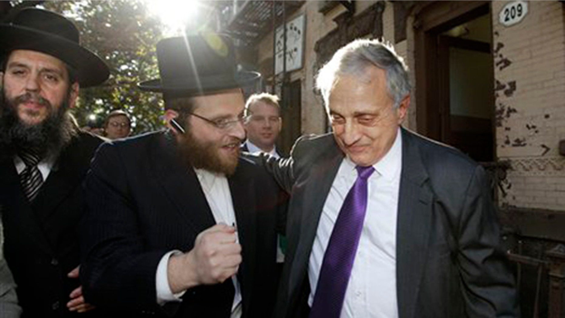 Rabbi Yechezkel Roth, left, and another Orthodox Jewish supporter, center, accompany New York Republican gubernatorial candidate Carl Paladino in the Williamsburg neighborhood of Brooklyn Oct. 10. (AP Photo)