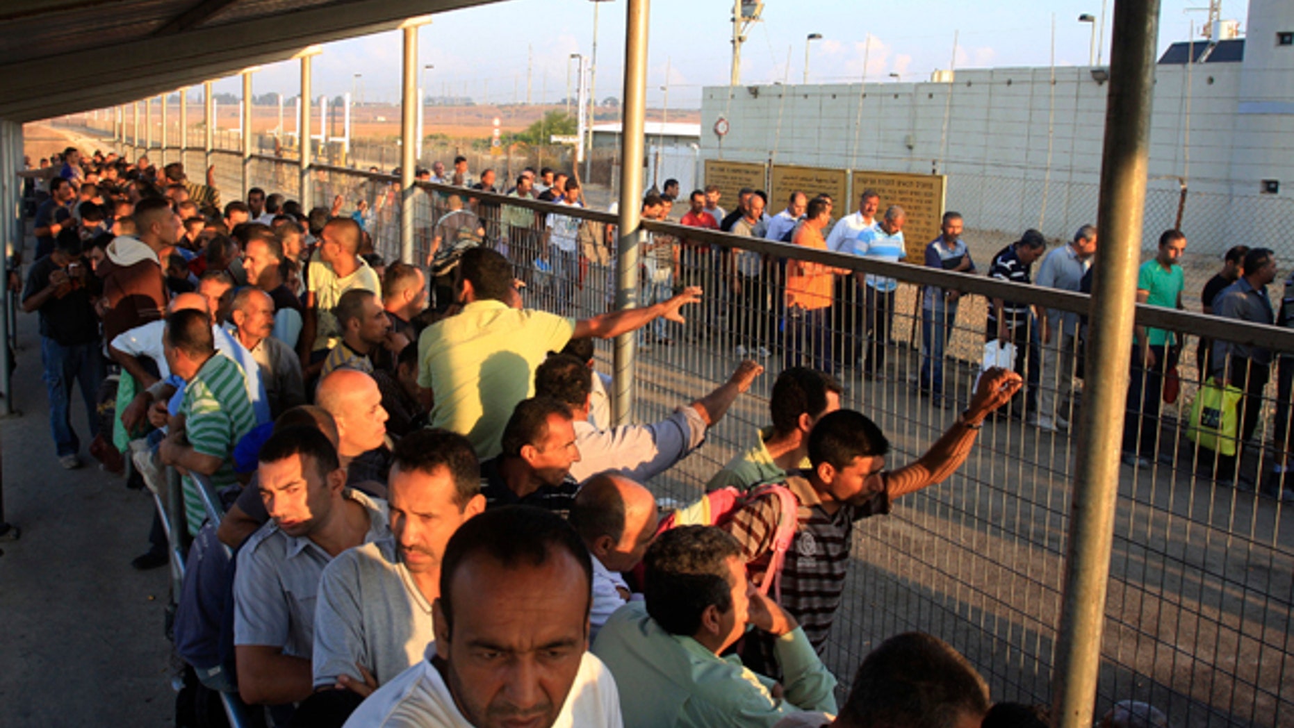 Oct. 9, 2012: Palestinian workers wait to cross to Israel at the Qalqiliya checkpoint. In response to an economic crisis gripping the West Bank, Israel has suddenly increased the number of permits for Palestinians to work inside Israel. (AP)