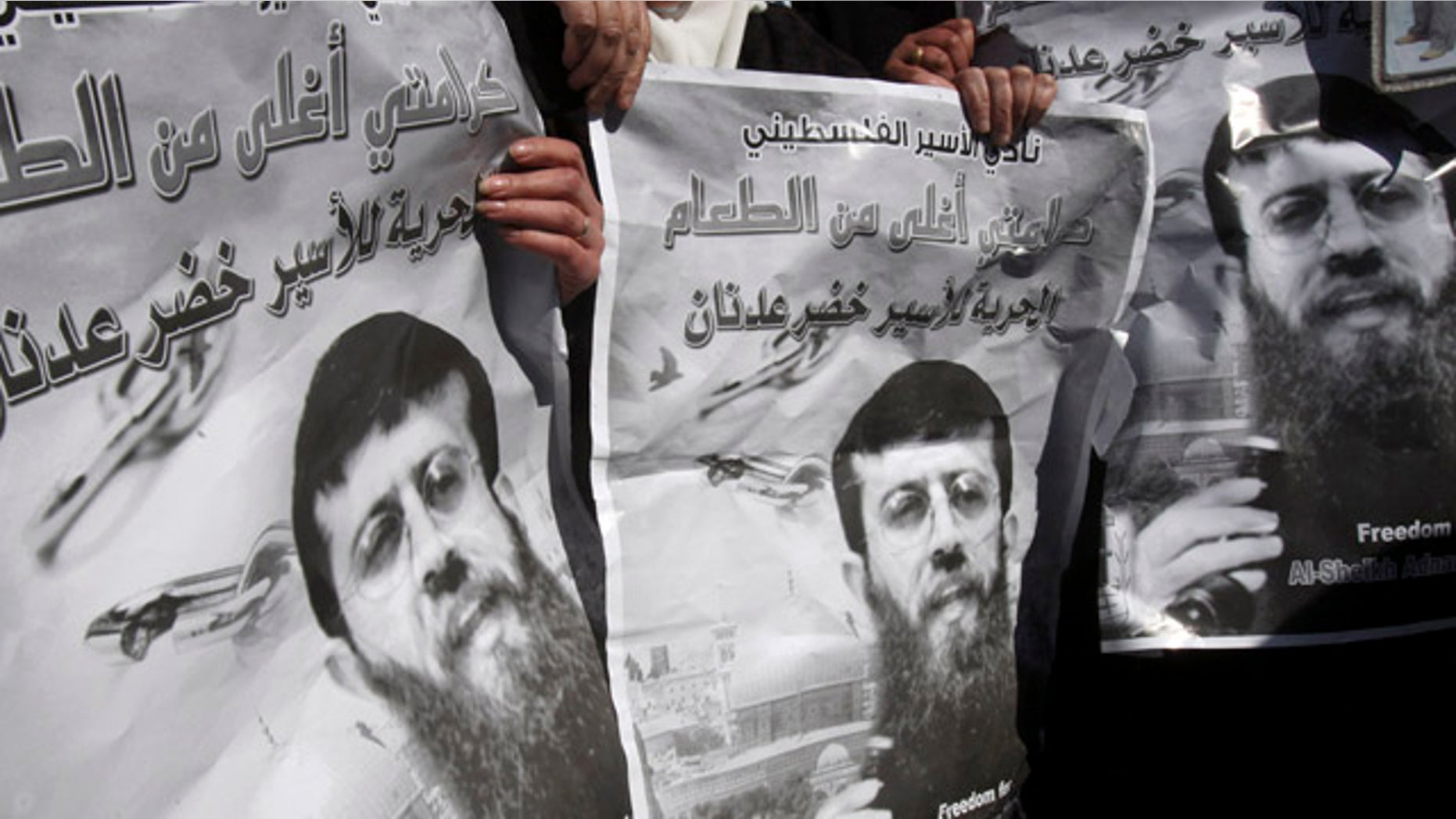 Feb. 21: Palestinians hold posters during a demonstration in solidarity with Islamic Jihad member Khader Adnan, who has been on hunger strike for two months, in the West Bank city of Nablus.