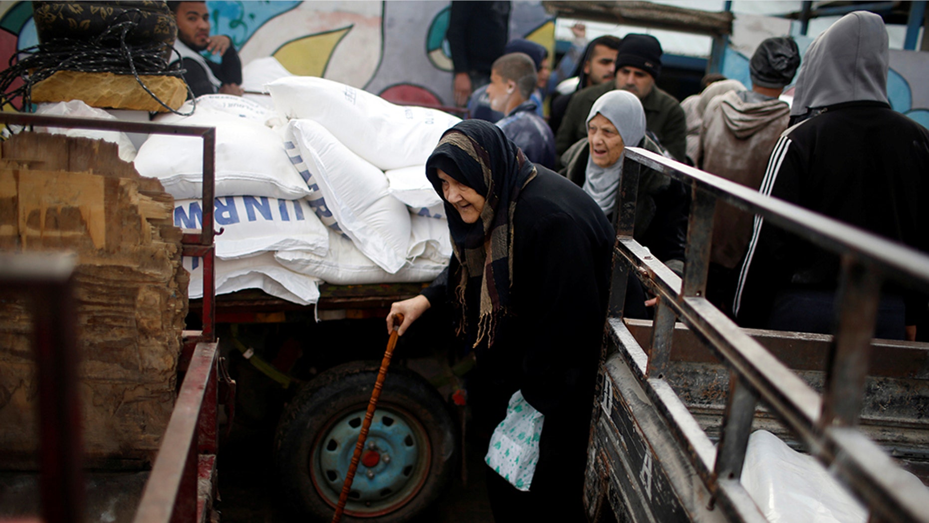A Palestinian refugee leaves a United Nations food distribution center after receiving aid in Al-Shati refugee camp in Gaza City in January.