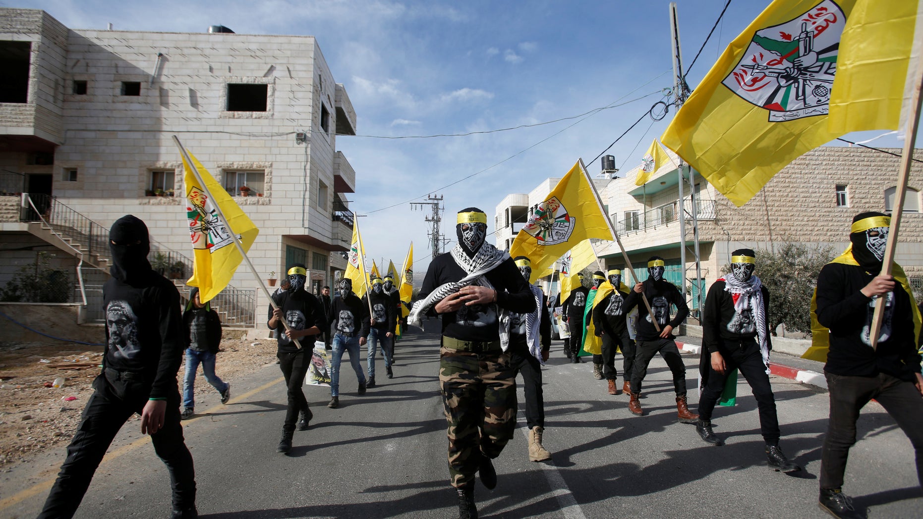 Masked men take part in the funeral of Palestinian youth Qusai Al-Amour, who Israeli and Palestinian officials said was shot dead by Israeli border police during a clash with protesters on Monday, in the West Bank village of Tuqu near Bethlehem January 17, 2017. REUTERS/Mussa Qawasma - RTSVWGC