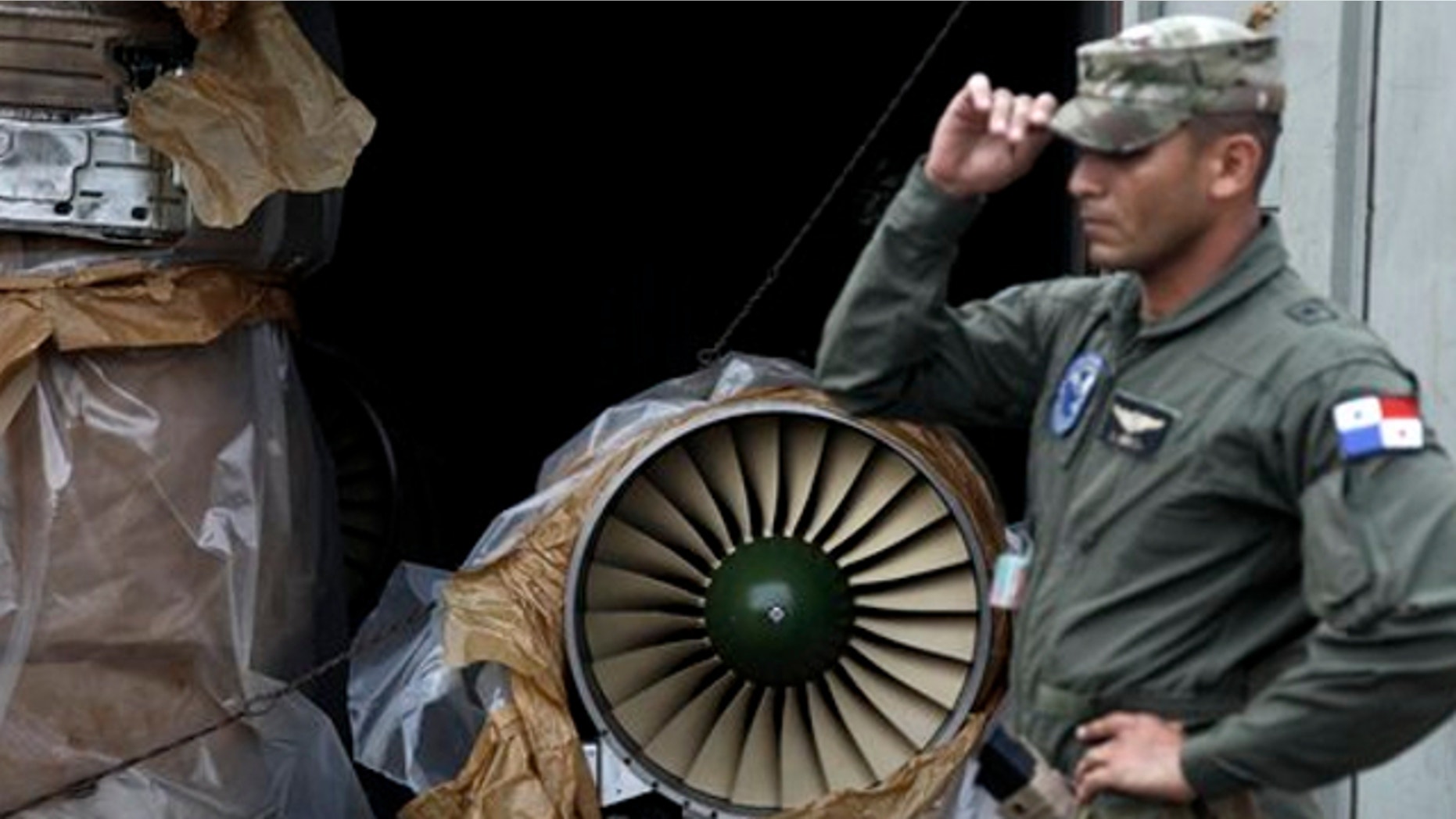 July 30, 2013: This photo shows a naval police officer standing in front of a container carrying a Russian-made fighter engine which was taken off the North Korean-flagged freighter ship Chong Chon Gang, during a press tour at the Manzanillo International container terminal in the port city of Colon, Panama.