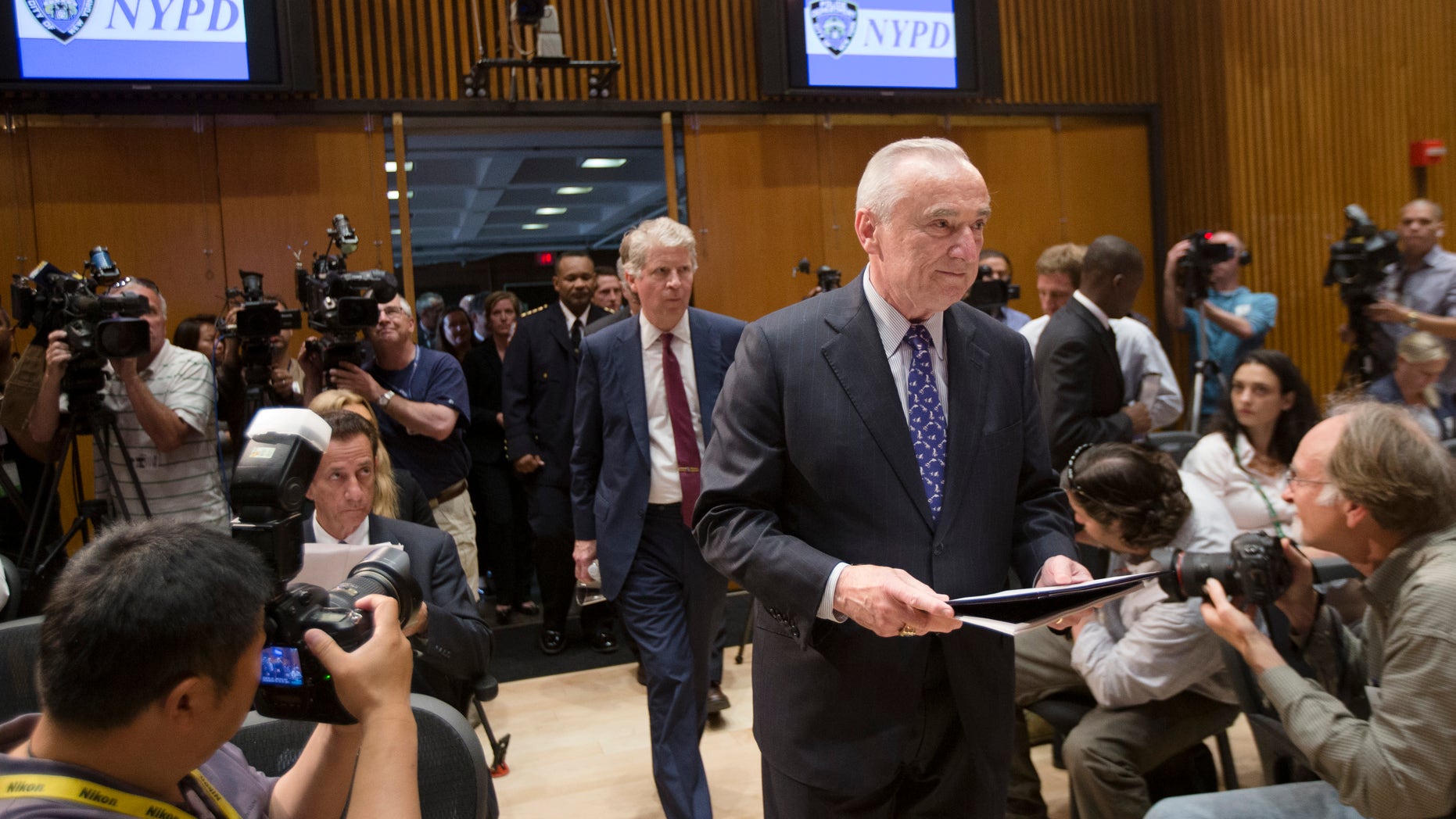 New York City police commissioner William Bratton enter a news conference Wednesday, June 4, 2014.