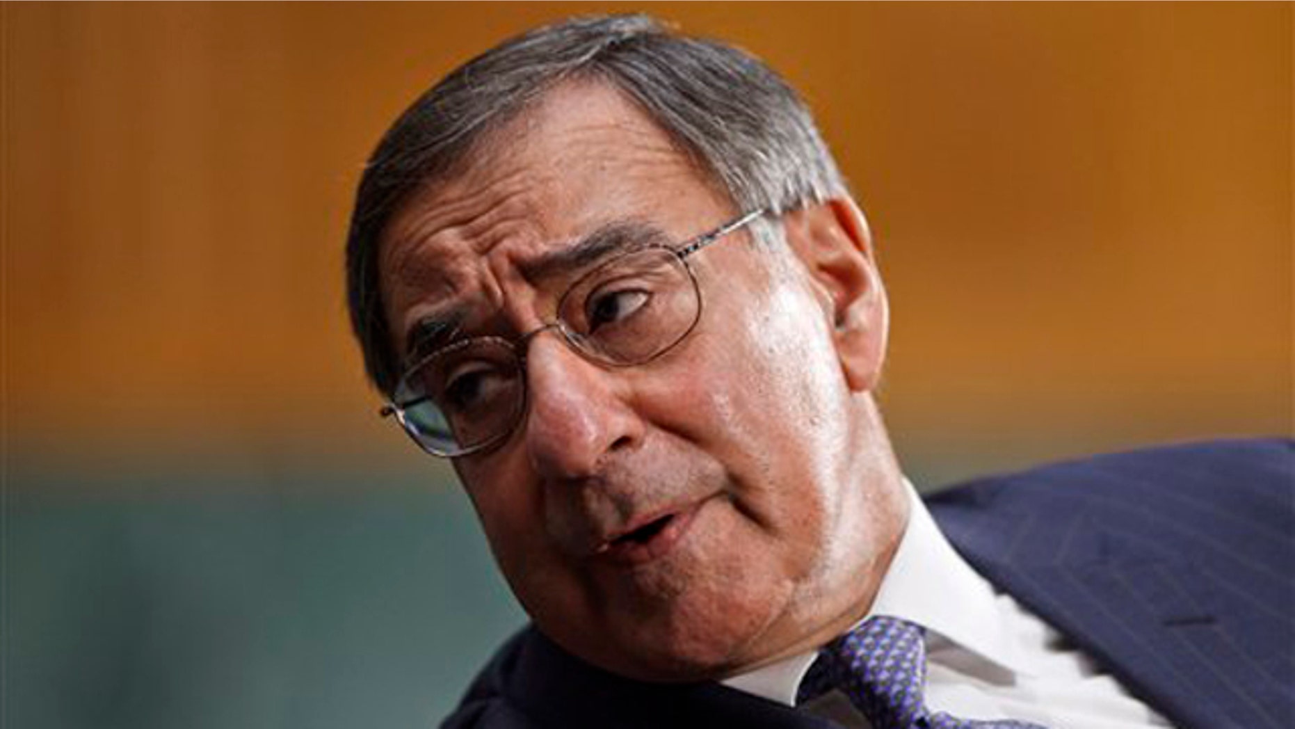 March 7, 2012: Defense Secretary Leon Panetta confers with an aide on Capitol Hill in Washington.