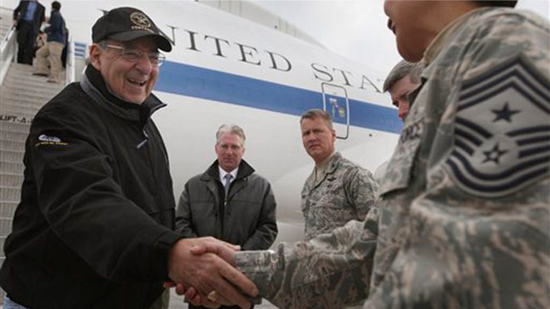 March 13, 2012: Defense Secretary Leon Panetta, left, is greeted as he arrives at the Transit Center at Manas, near Bishkek, Kyrgyzstan.