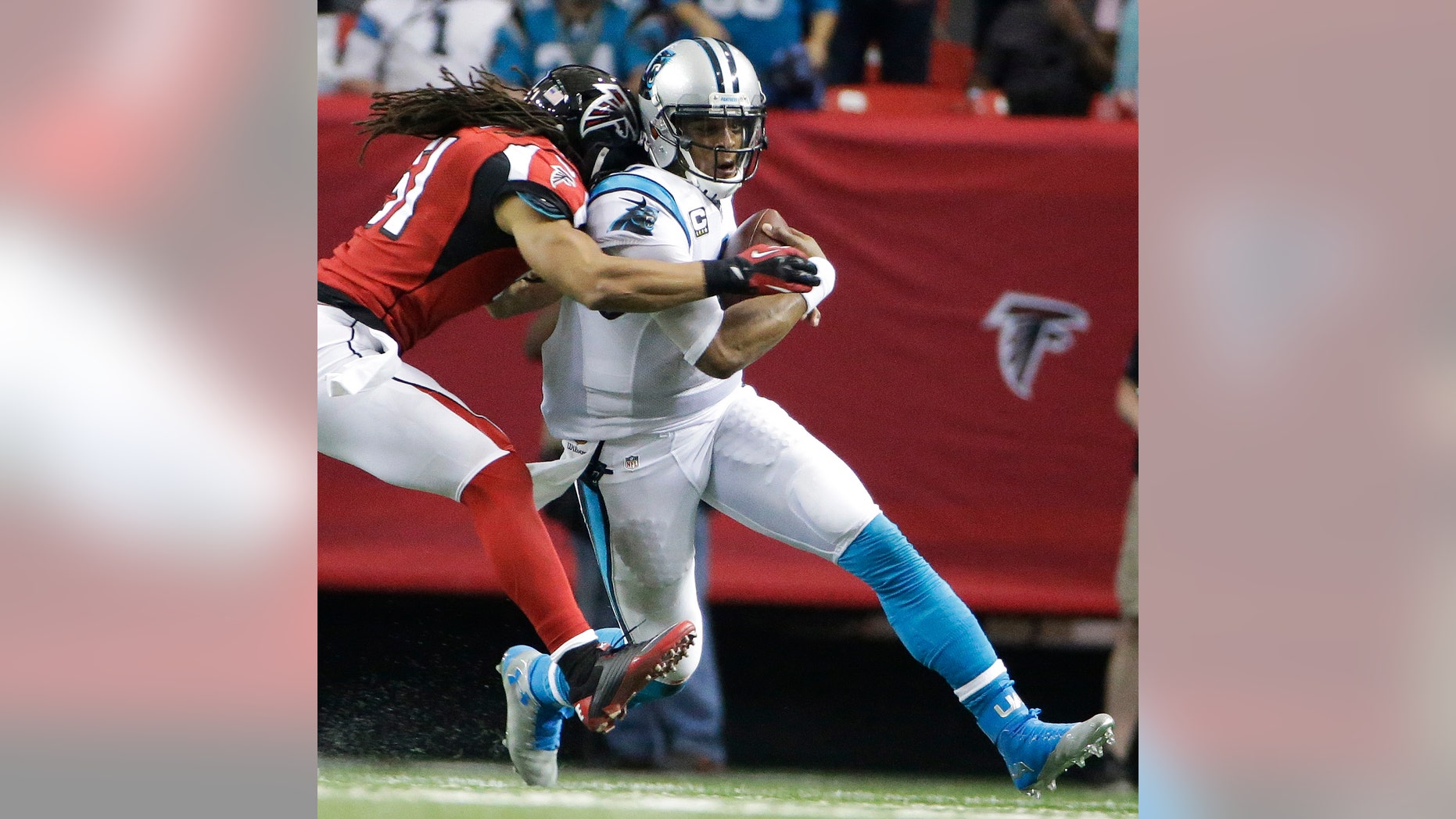 Falcons linebacker Philip Wheeler hits Panthers quarterback Cam Newton during the second half of a football game.